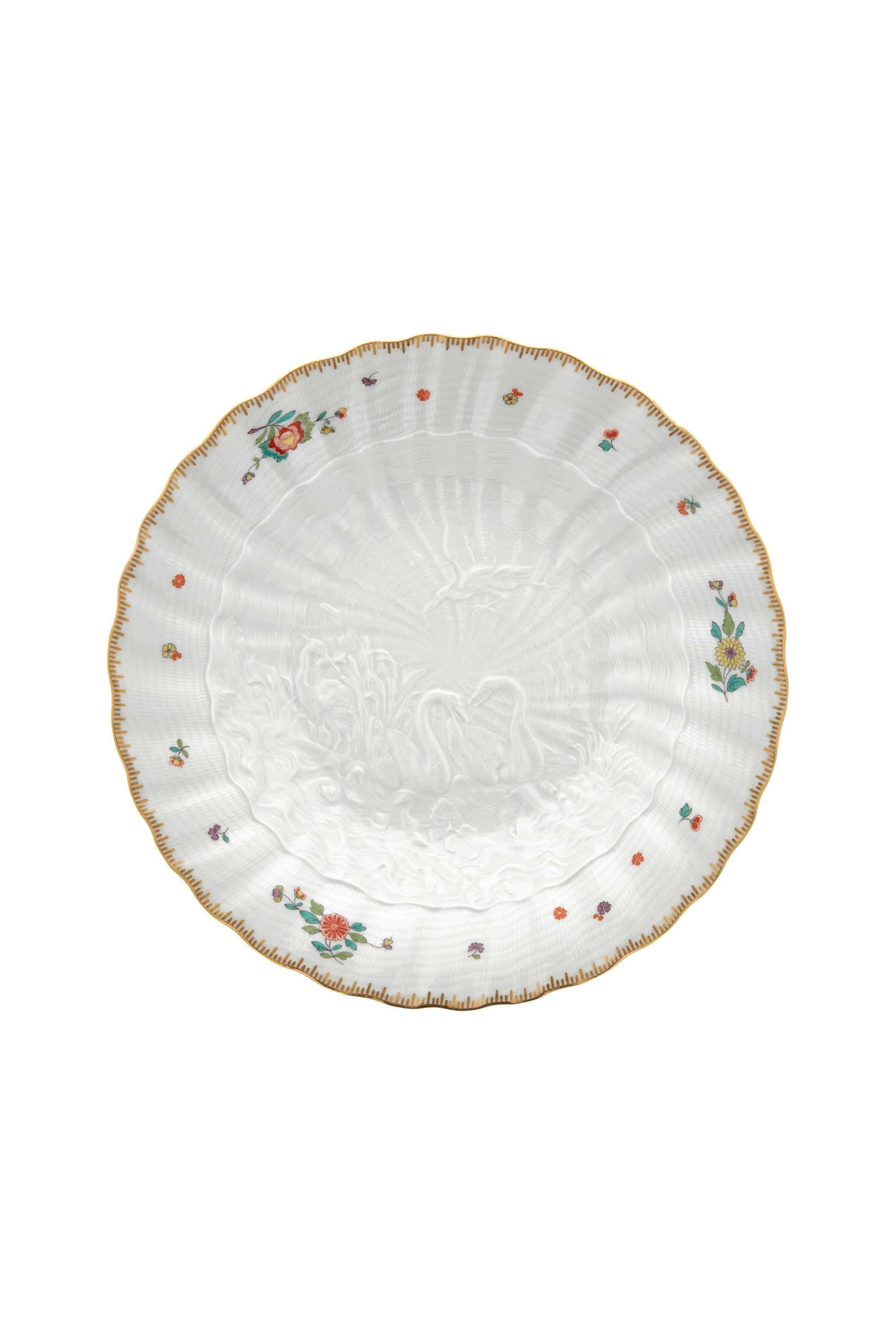 Designed by Johann Joachim Kändler, the pattern features a delicate background with radiating bands based on a scallop shell and a central well dressed with a pair of swans on water amid bullrushes, swooping cranes, and fish. Several parts of the service depict figures from Greco-Roman mythology, like Glaucus and the dolphin-riding Galatea.