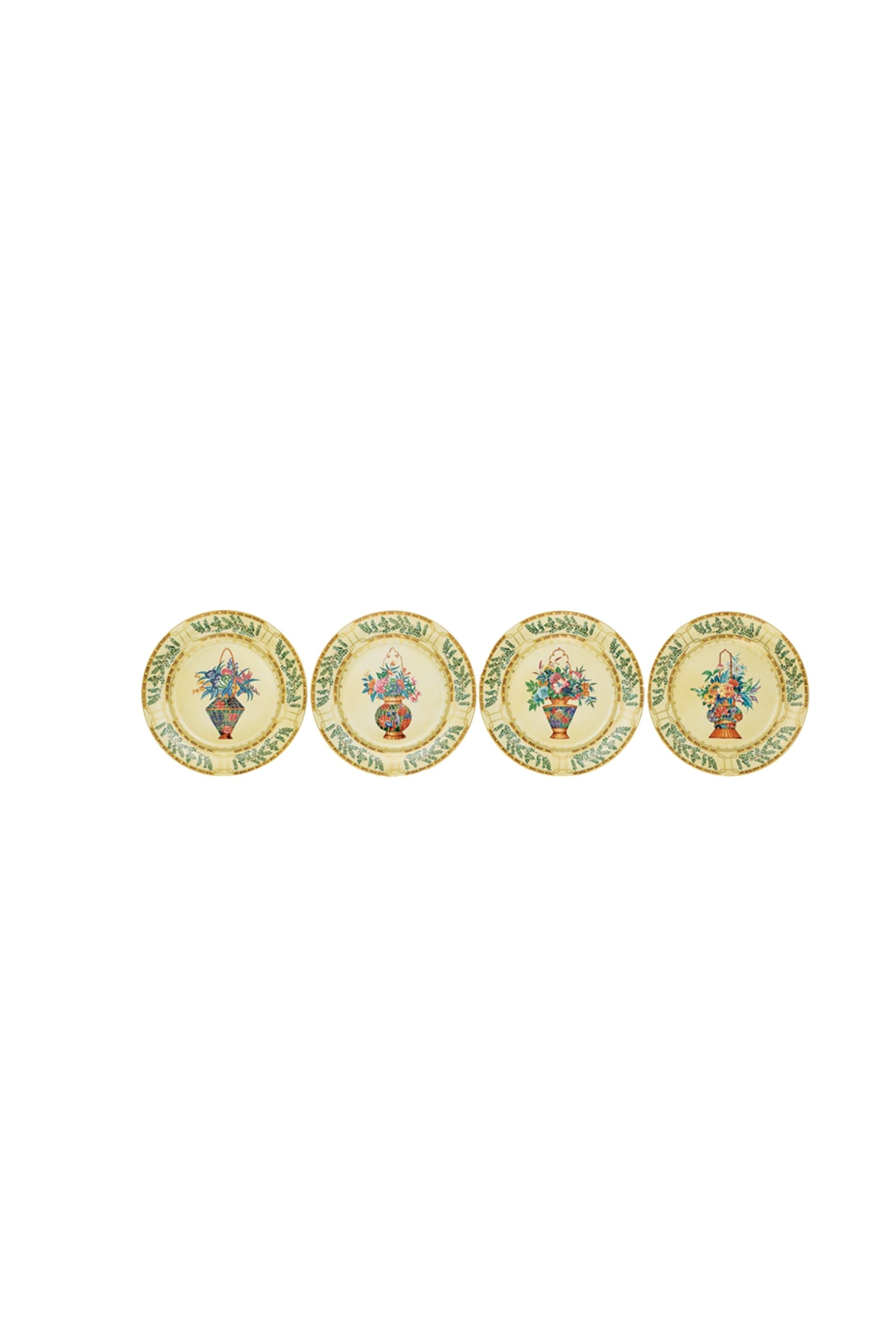 Chinese dinnerware. The decoration incorporates blossoming trees, hanging baskets of flowers, and exotic birds.