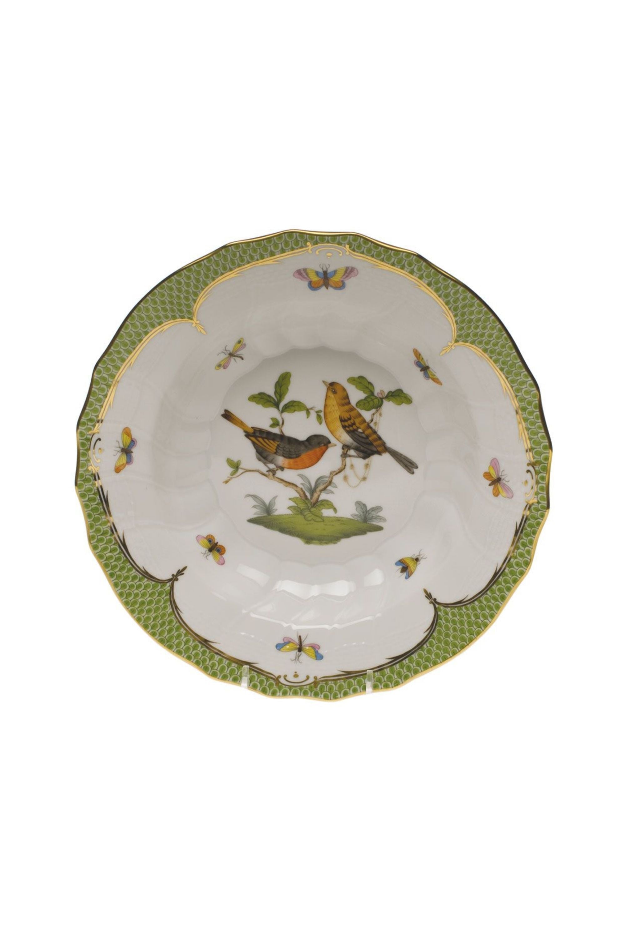 Green porcelain dinnerware. Rothschild Bird is a lush design featuring the highly recognizable bird motif framed by tiny hand-painted fish scales outlined in 24-karat gold.