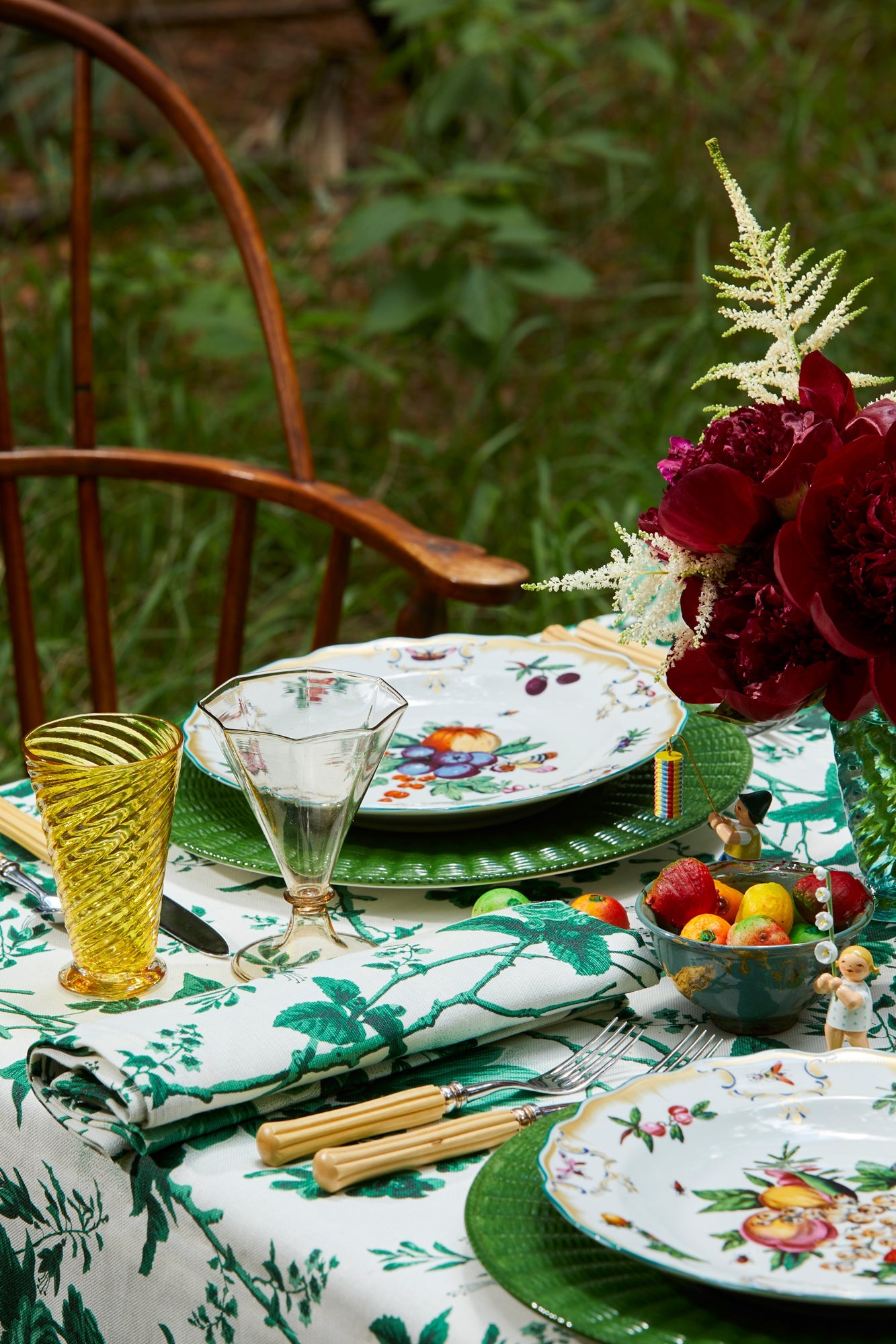 Green ceramic service plate trimmed in a wicker basket pattern.