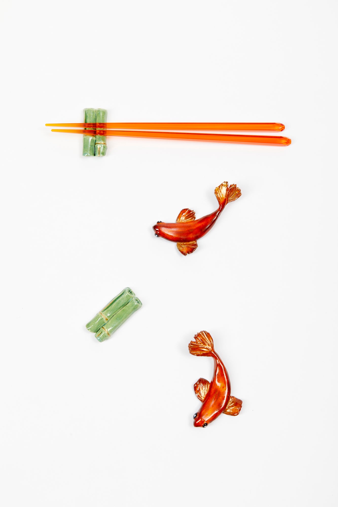Handmade and glazed ceramic kois to be used as chopstick rests or figurines.
