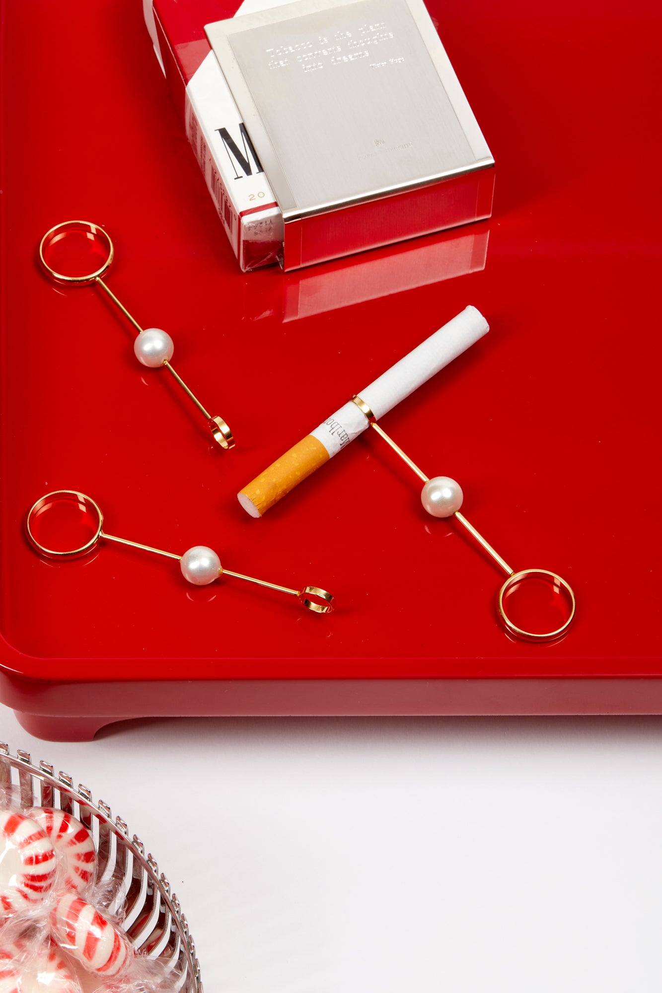 Glamorous gold and pearl cigarette holders.