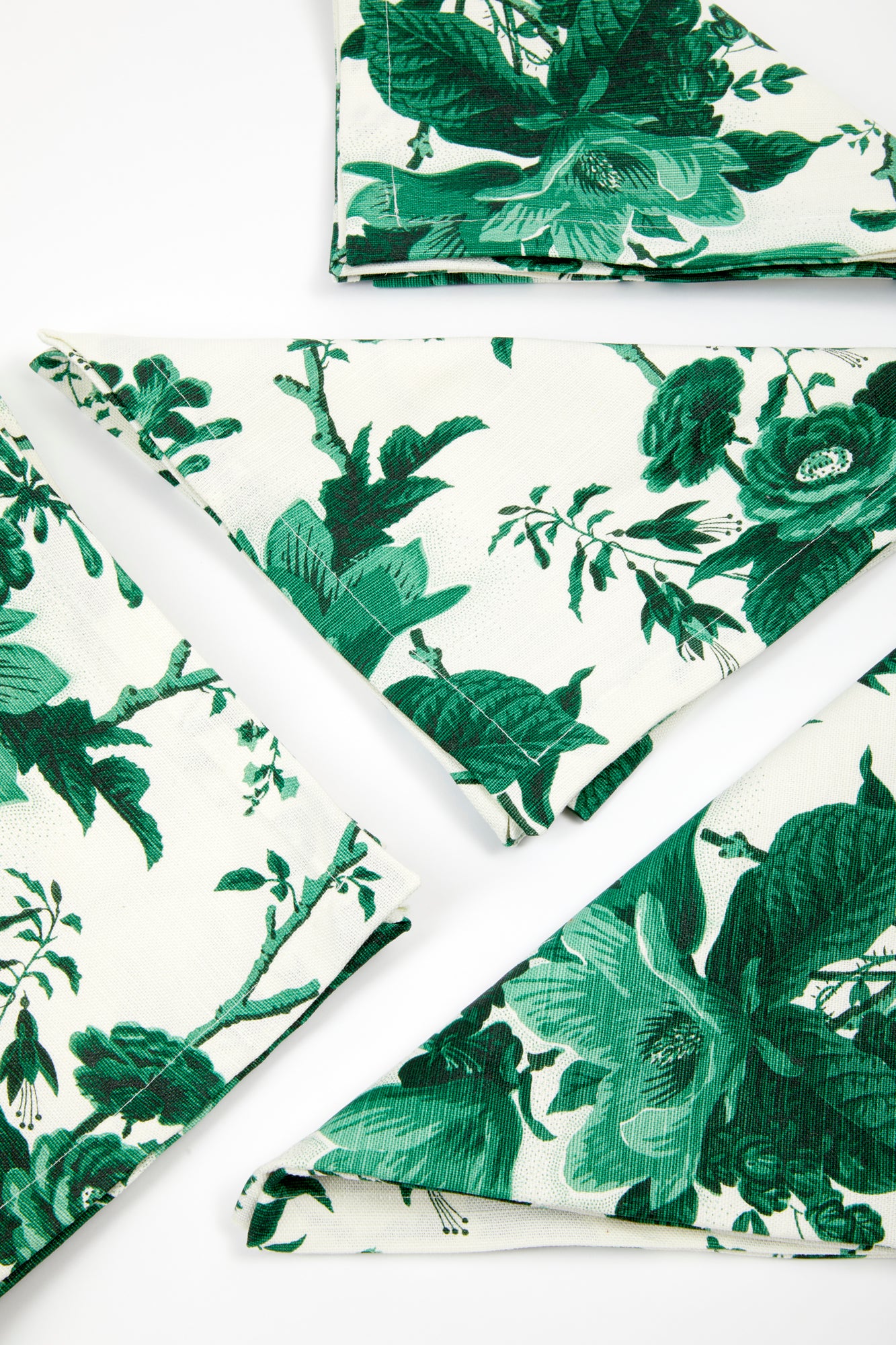 Set of dinner napkins in "De La Tour" floral Union Linen pattern, a green and white realistic floral print.