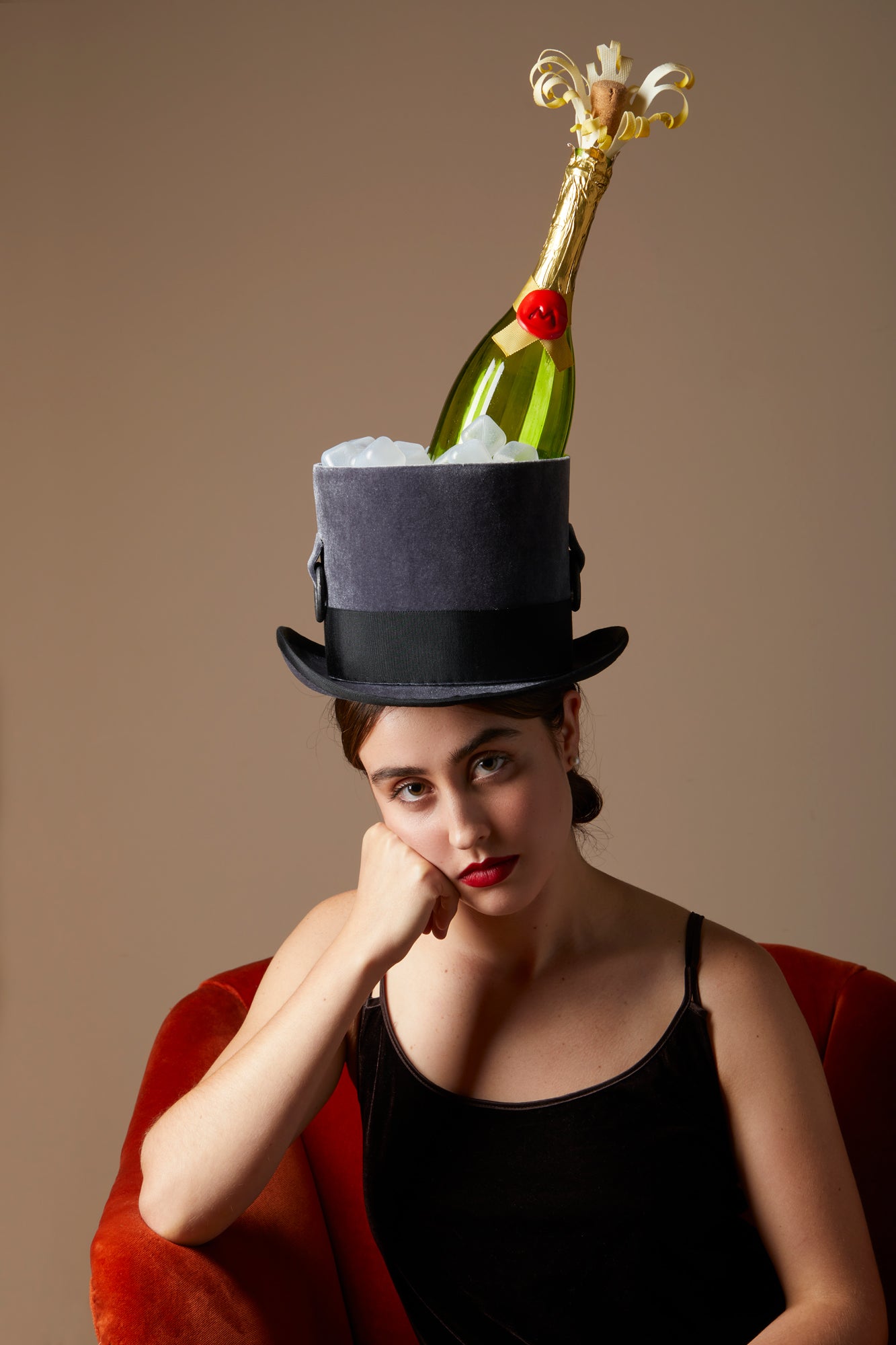 This velvet top hat and has a Champagne bottle with ice cubes. Incredible details like silk bonded champagne sprays and wax seals are works of art. Handmade by a milliner Tel Aviv.