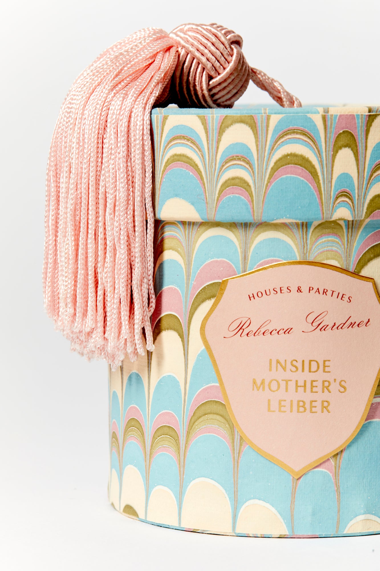 Glamorous silver glass candles come in boxes wrapped with our signature artisan marbled paper and crowned with a sumptuous blush tassel.