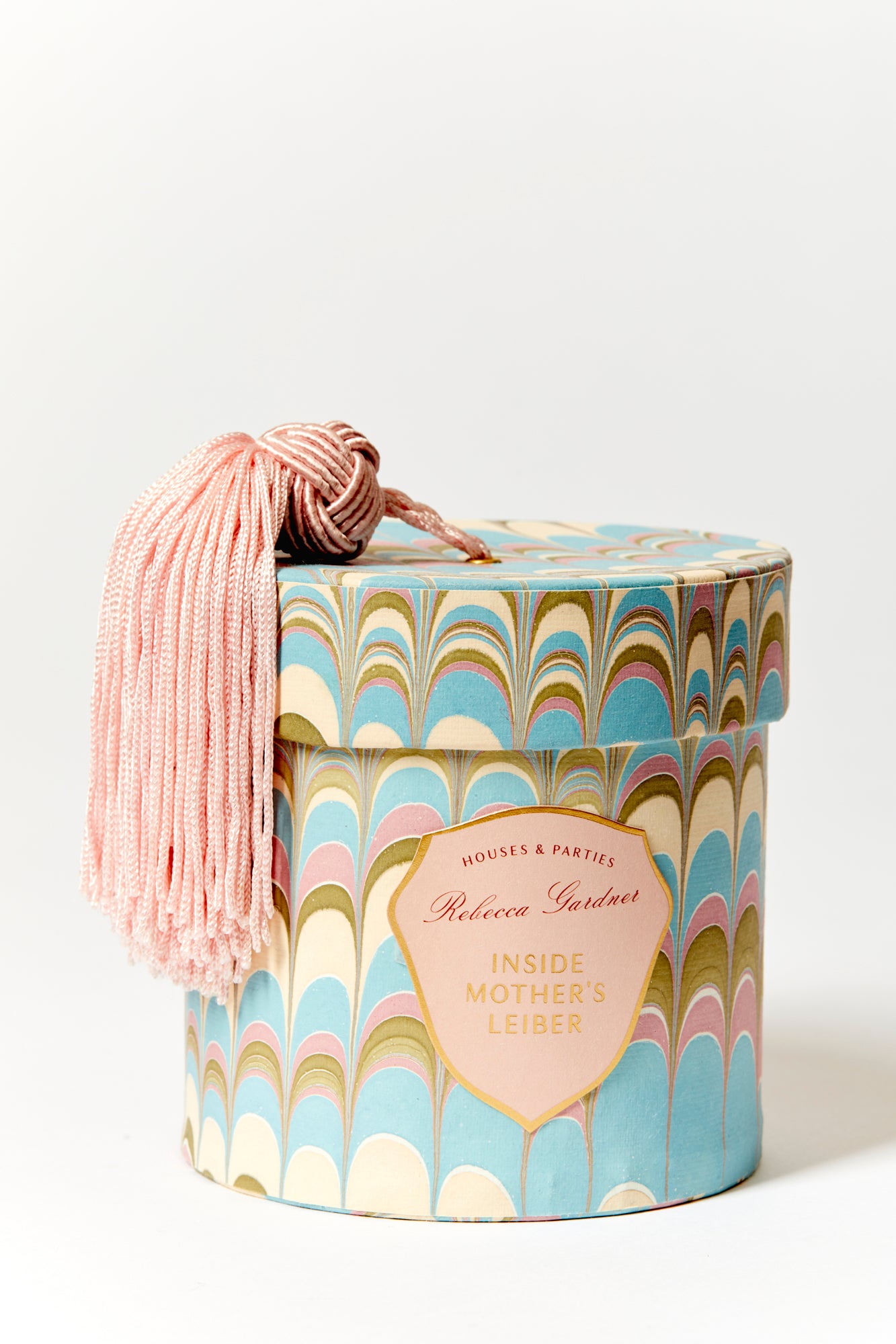 Glamorous silver glass candles come in boxes wrapped with our signature artisan marbled paper and crowned with a sumptuous blush tassel.