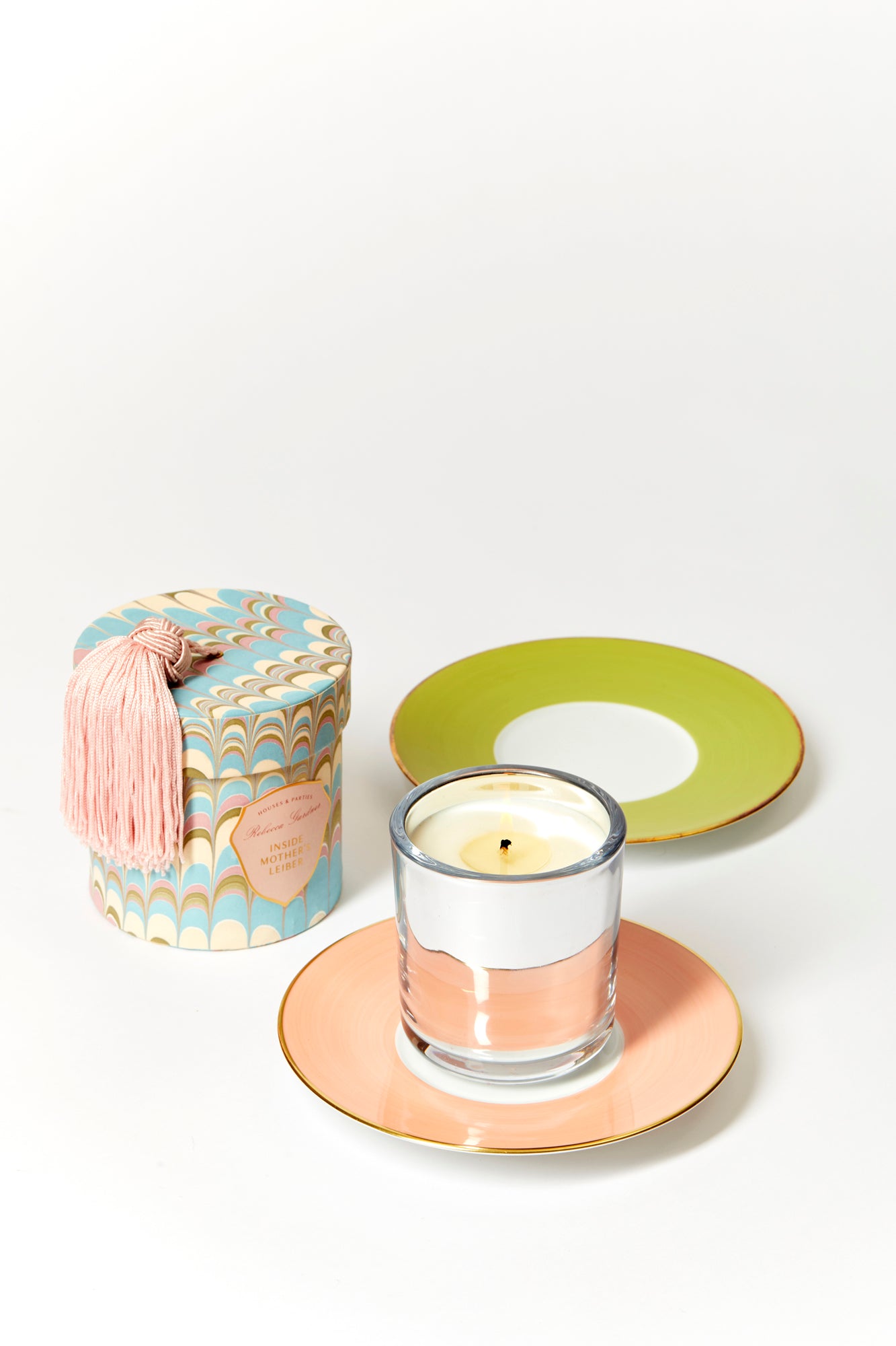 Glamorous silver glass candles come in boxes wrapped with our signature artisan marbled paper and crowned with a sumptuous blush tassel.