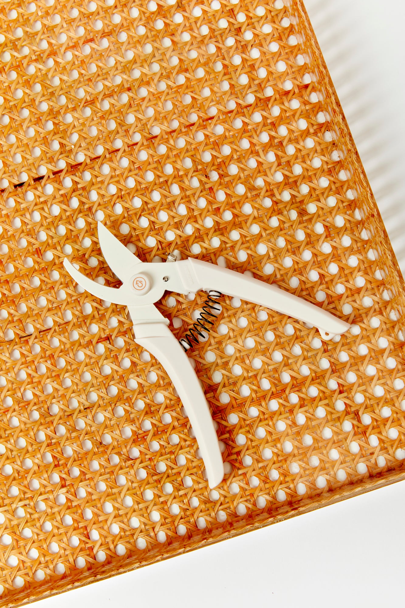 The essential tools for creating floral arrangements: floral netting, tape and scissors.