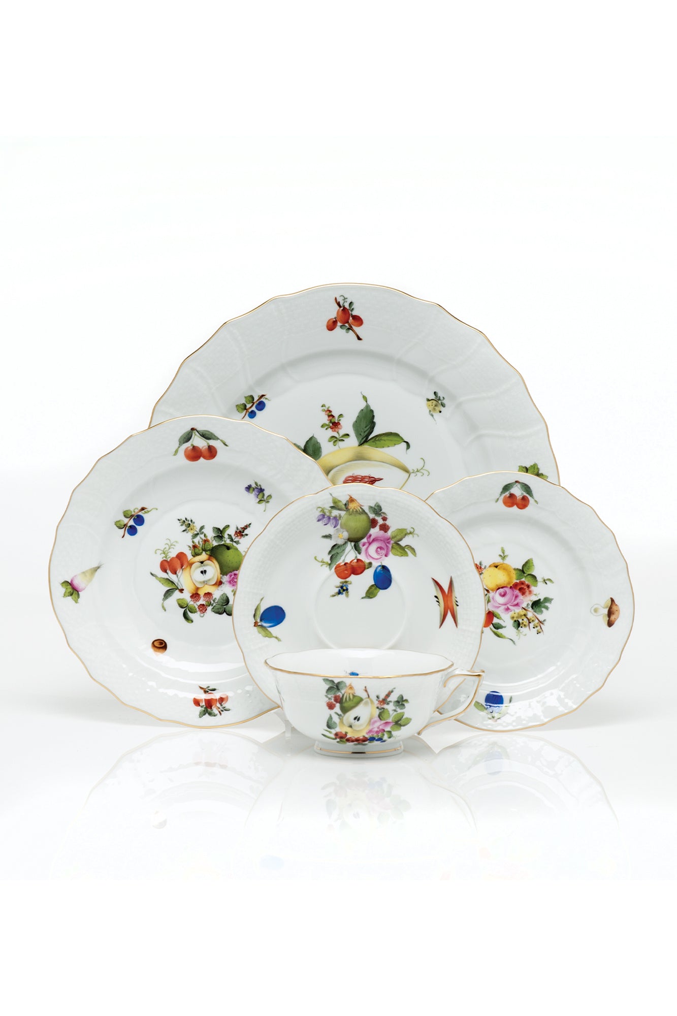 Porcelain dinnerware that has playful pattern surprises with tiny pink radishes, mushrooms and acorns.