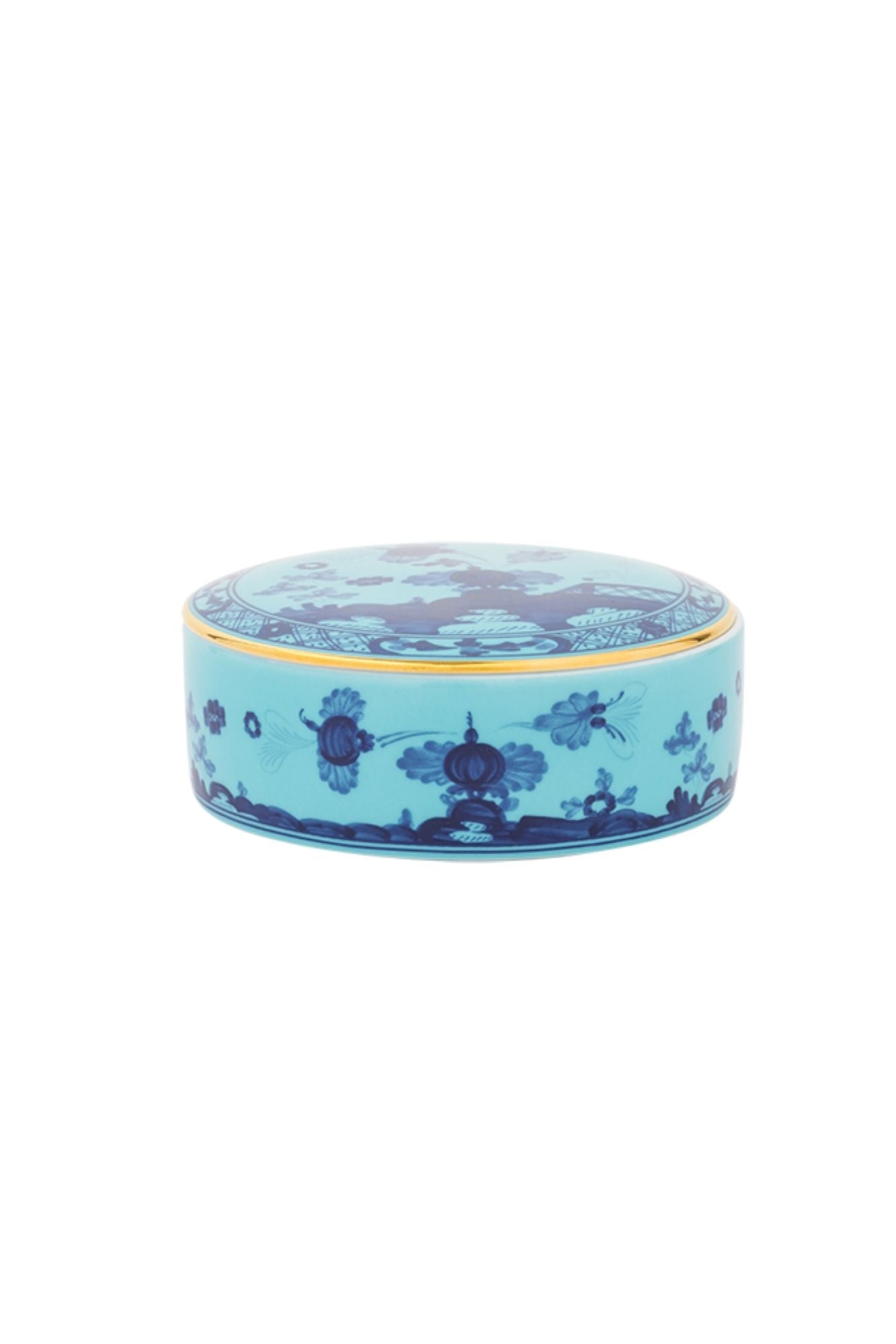 This turquoise and blue porcelain in Ginori’s traditional Antico Doccia shape is decorated with a stylized carnation reinterpreted by Gio Ponti in 1946. 24-karat yellow gold accents each piece.
