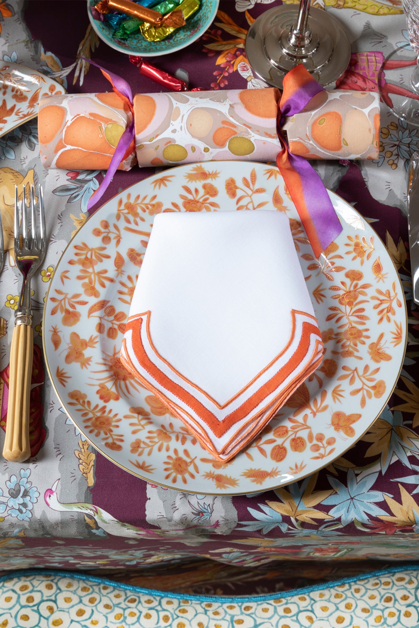 Tangerine linen napkin in an unusual scalloped design with embroidery and French stitch appliqué made in Madeira, Portugal.