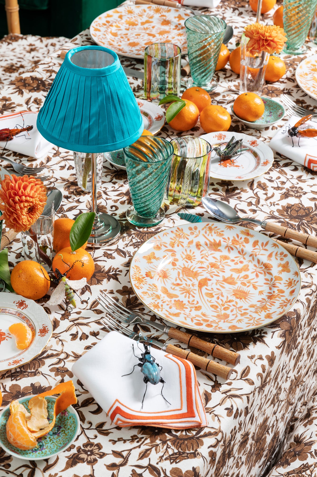 Sacred birds in orange print. Five piece place setting includes dinner plate, dessert plate, bread & butter plate and teacup with saucer.