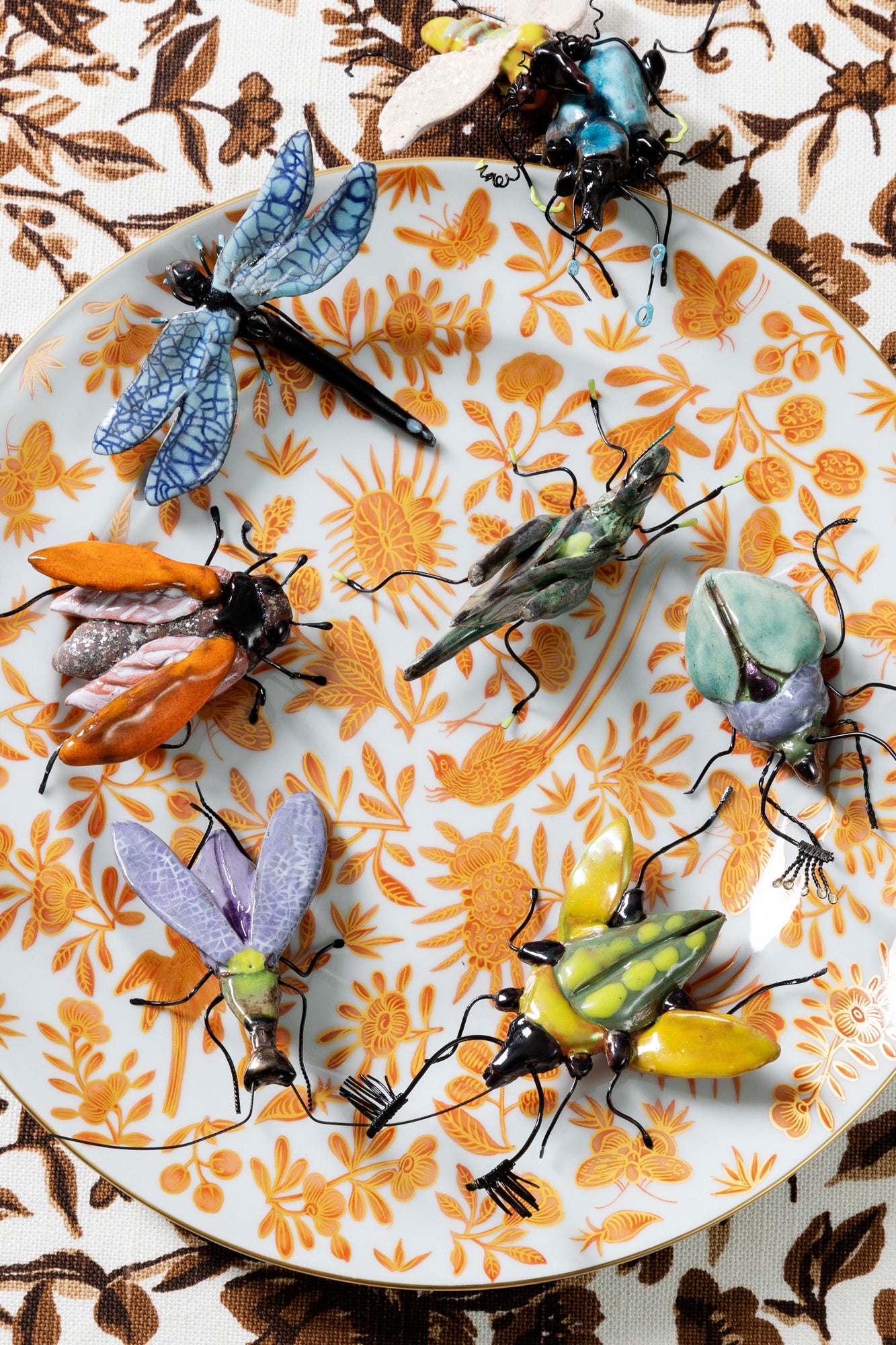 Handmade ceramic insects in various shapes, glazes, and guises.