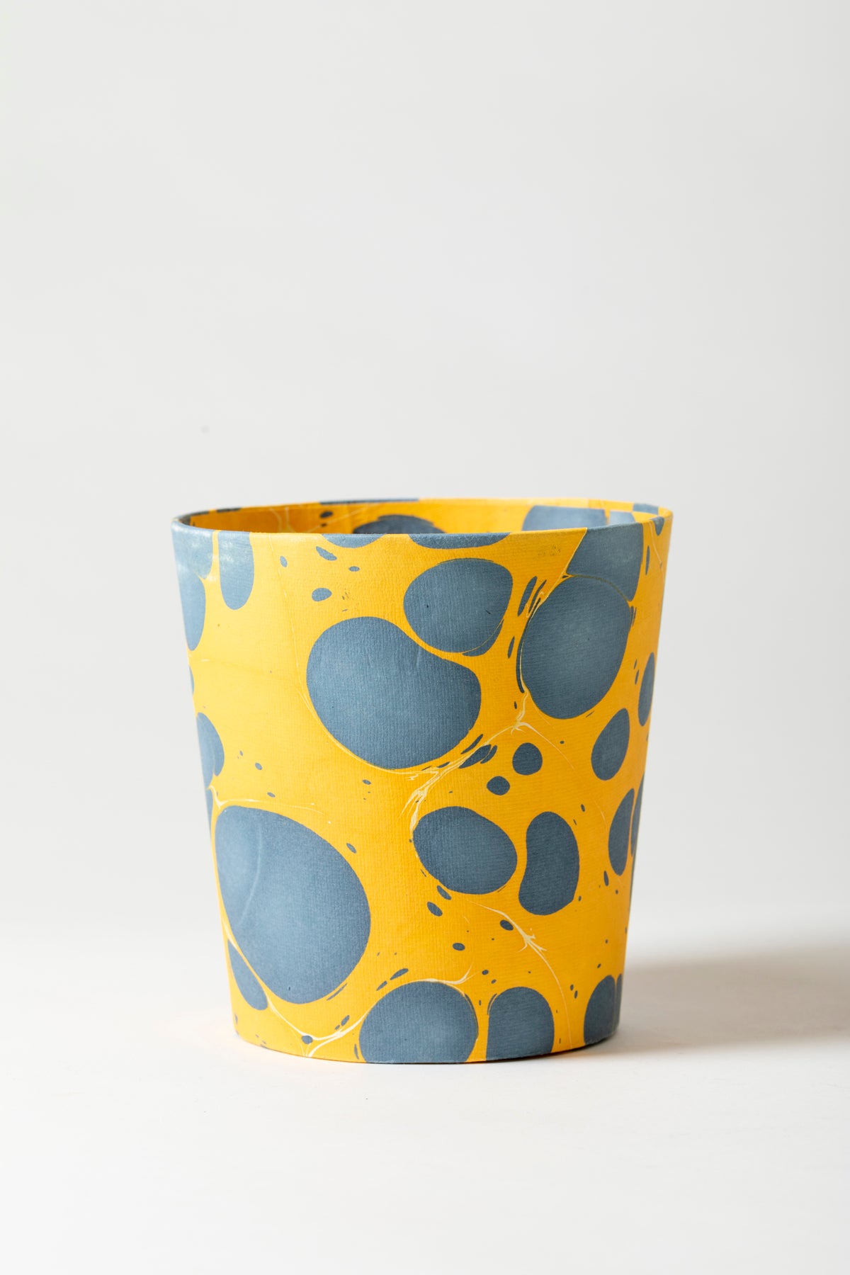 Artisan paper-covered cachepots with a plastic liner. Made to fit pots of standard seasonal bulbs or orchids.