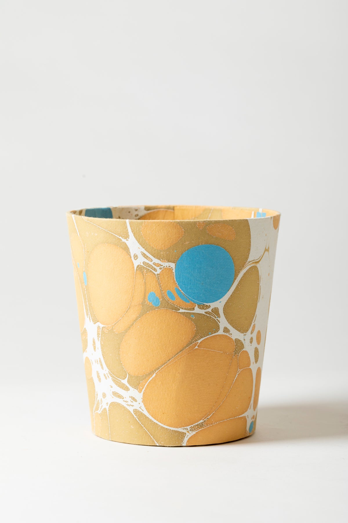 Artisan paper-covered cachepots with a plastic liner. Made to fit pots of standard seasonal bulbs or orchids.