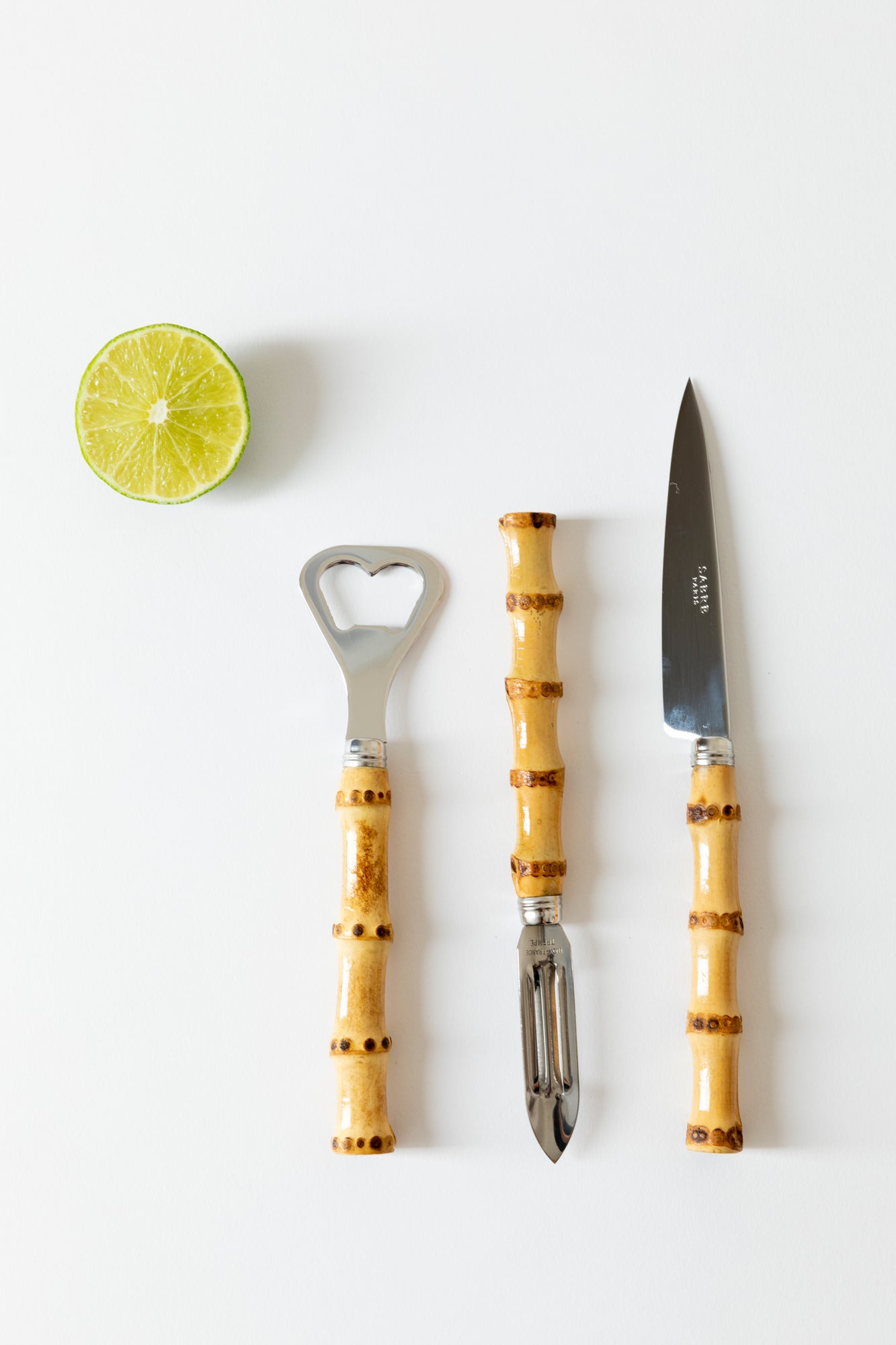 Bamboo citrus peeler, paring knife and bottle opener.