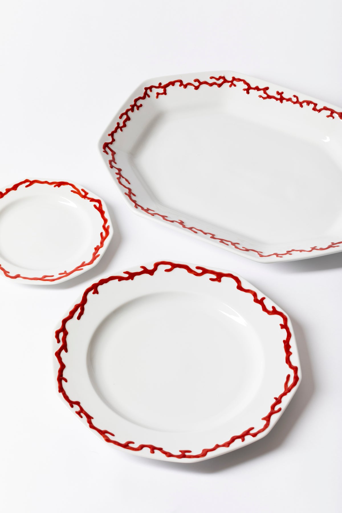 Uniquely beautiful patterned plates with a necklace of raised hand-painted red coral on the shoulder.