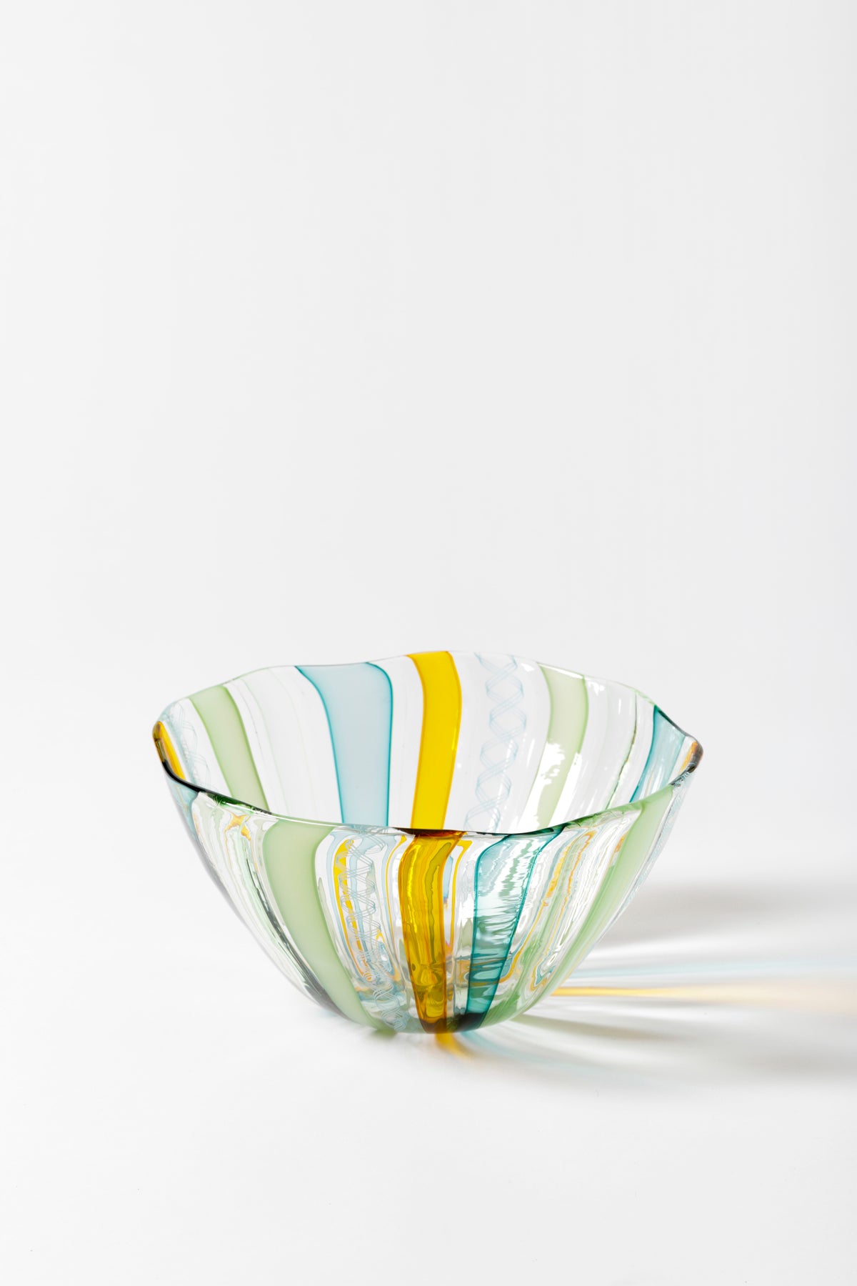 Handblown glass bowl with celadon and saffron ribbons.