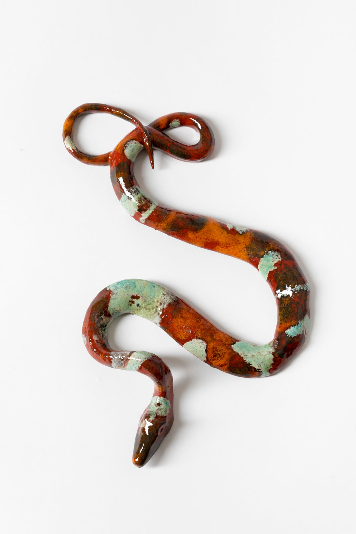Ceramic snake glazed with brown, red, and teal.