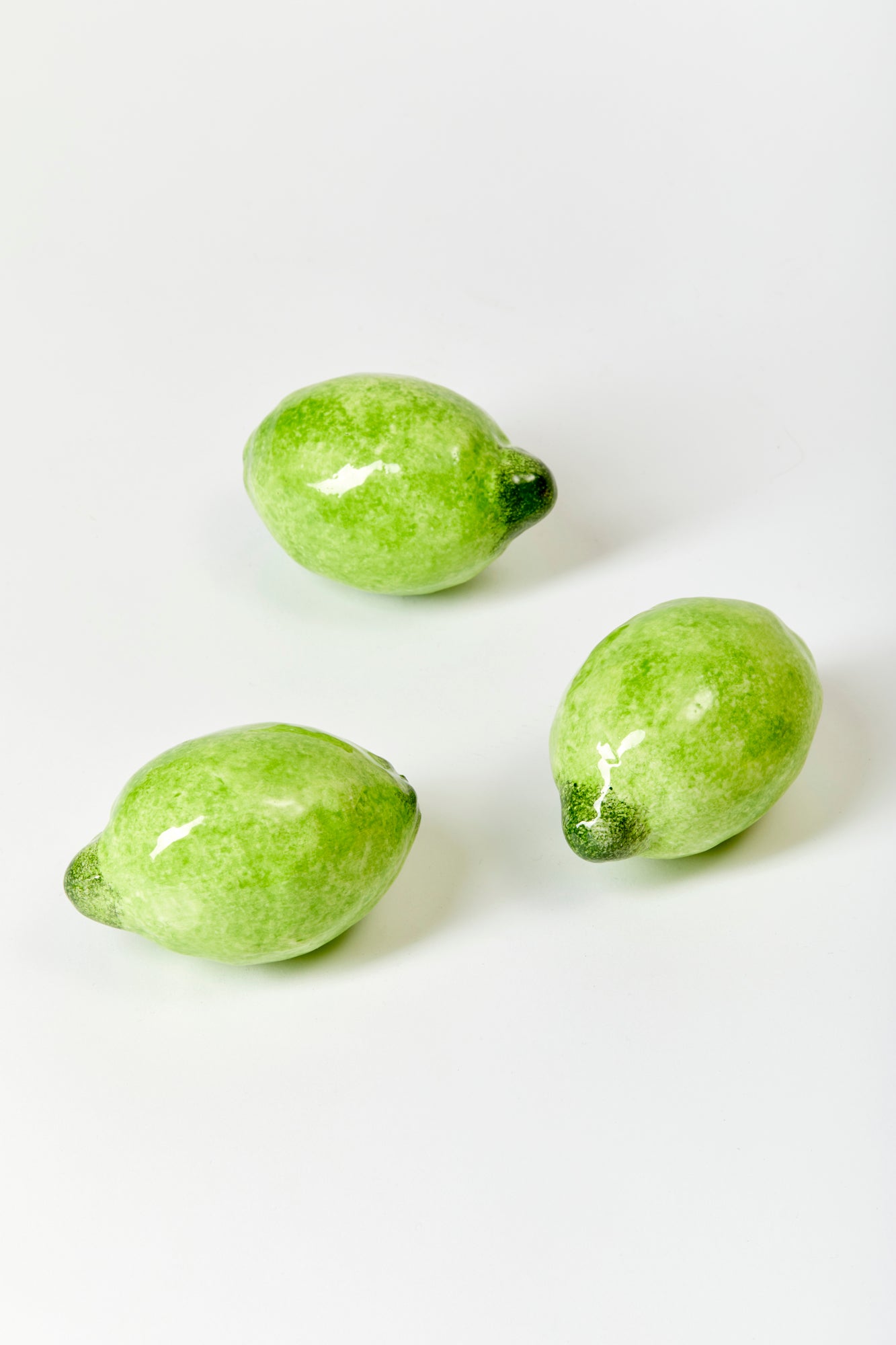 3 ceramic limes against a white background.
