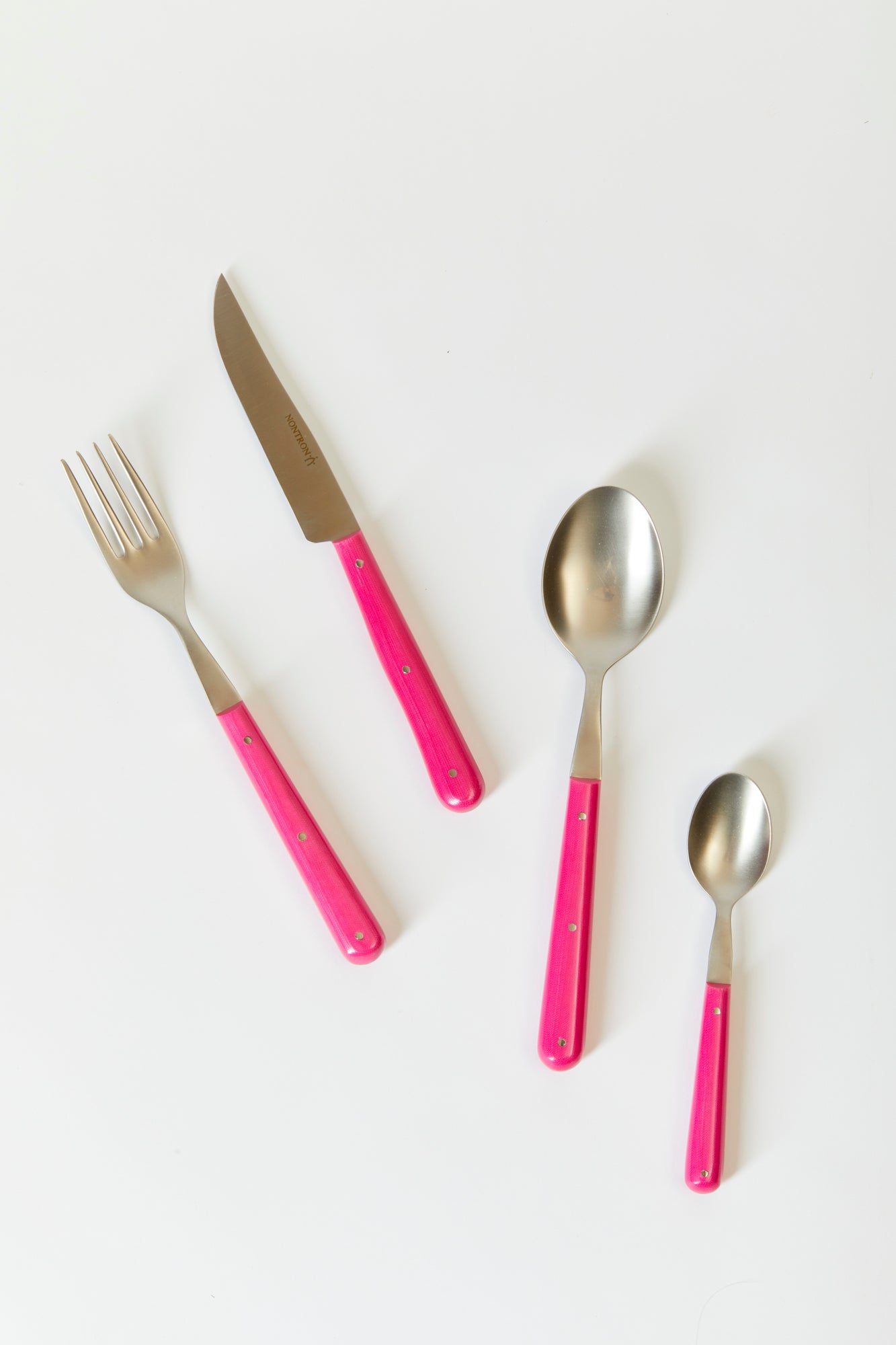 Hot pink flatware. Made in France by a historic knife-maker whose work dates back to the 18th century.