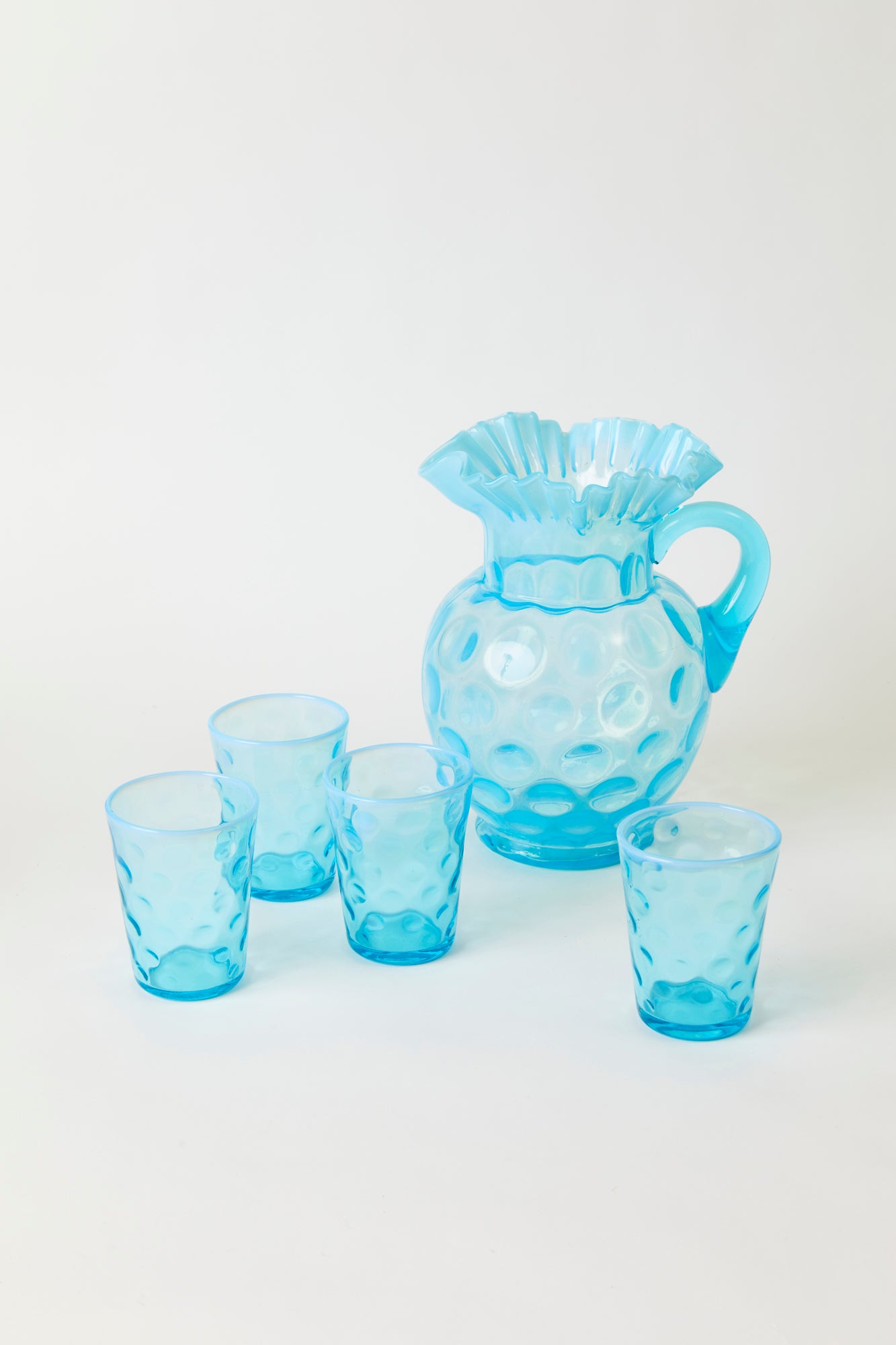 Vintage Fenton coinspot pitcher has a charming ruffled lip and four matching tumblers.