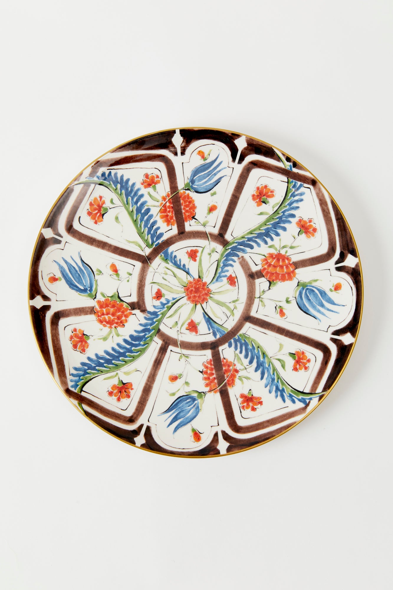 Earthenware plates with a glost-fired Iznik pattern of tropical flowers, designed and hand-painted by a family of artisans in historic Milan.