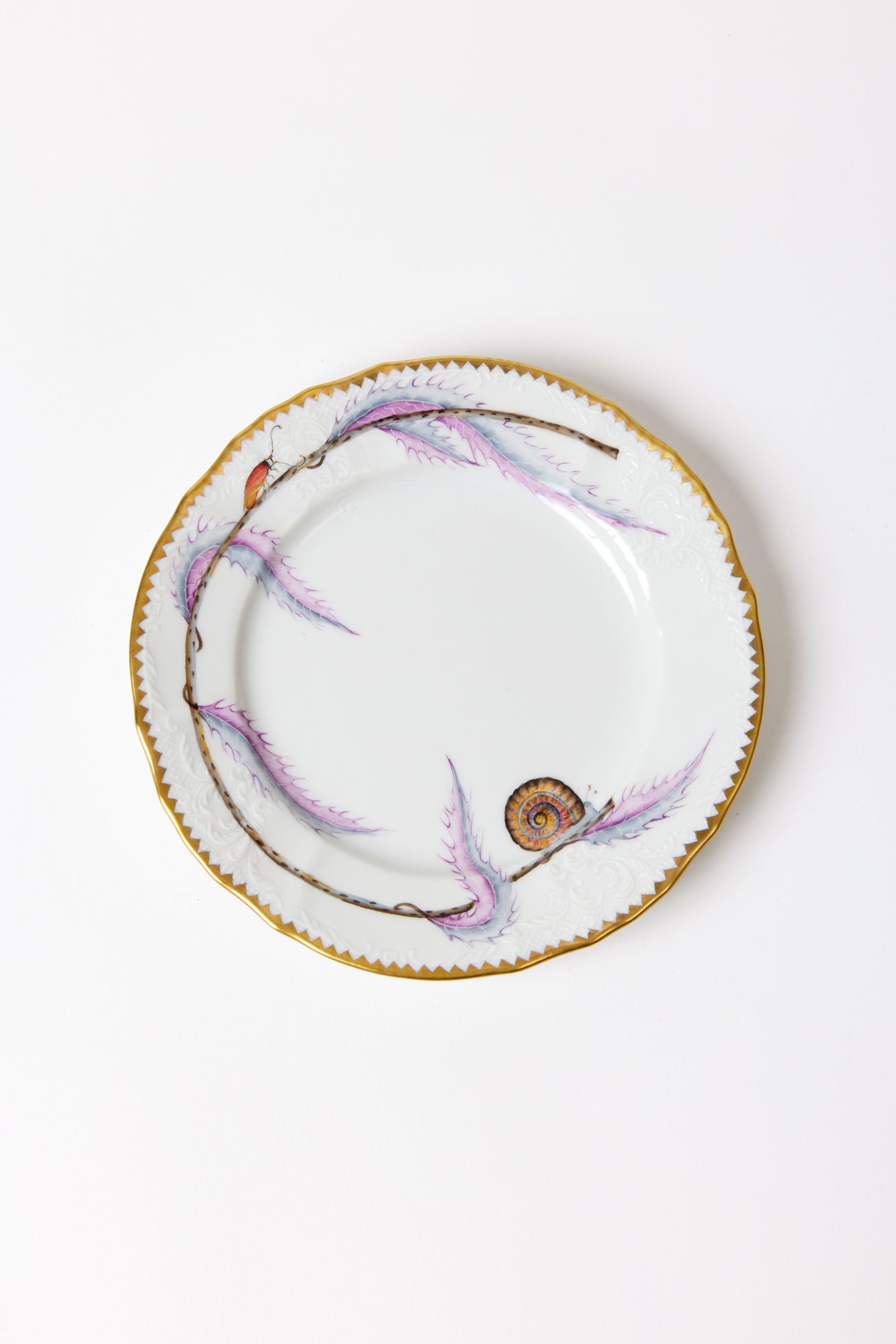 Fine porcelain plates, evocative of wild fairytale foliage from behind the castle wall.