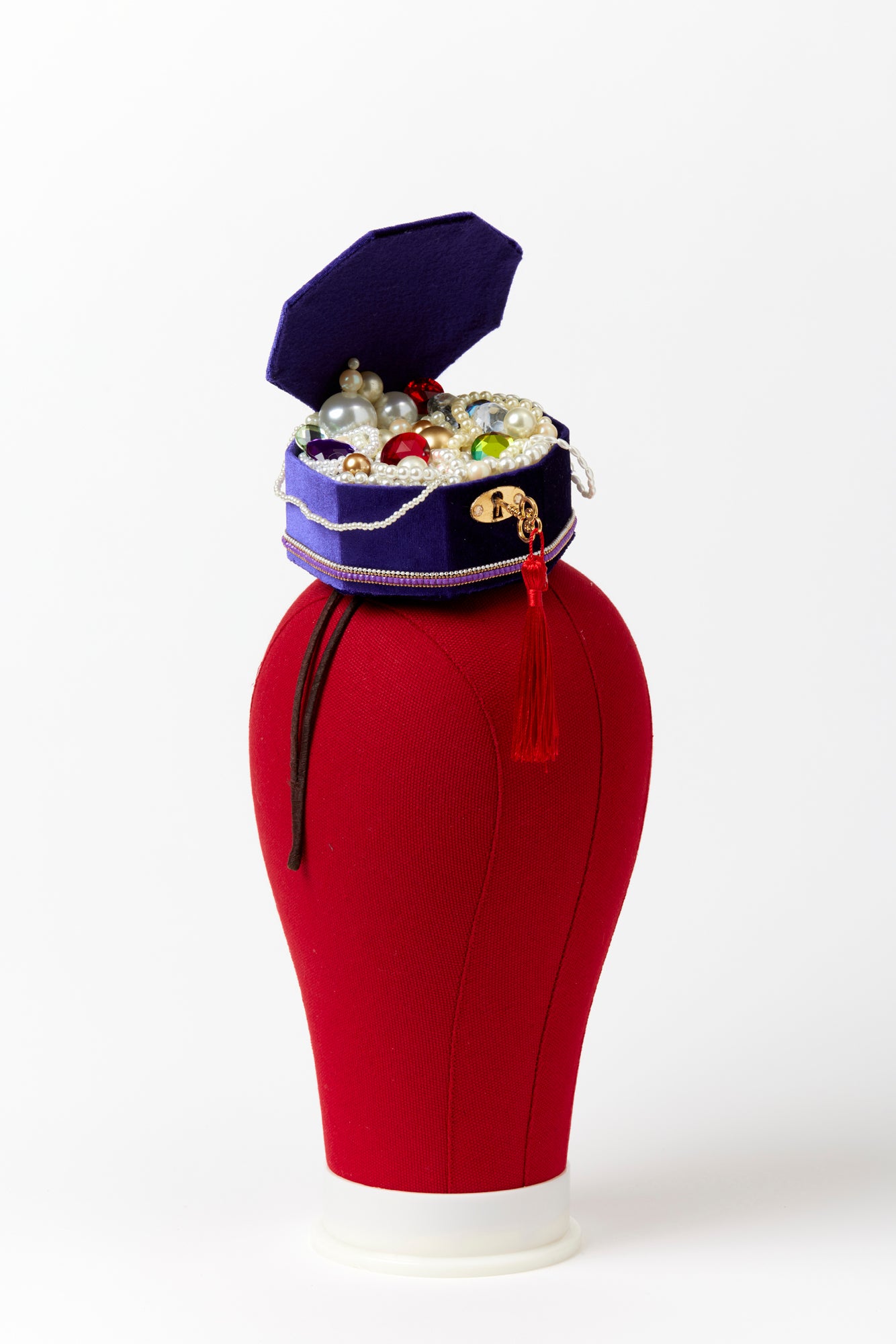 Headband with jewel box that includes pearls and jewels.