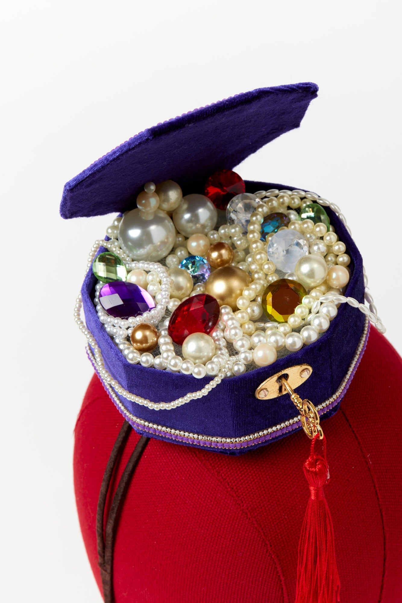 Headband with jewel box that includes pearls and jewels.