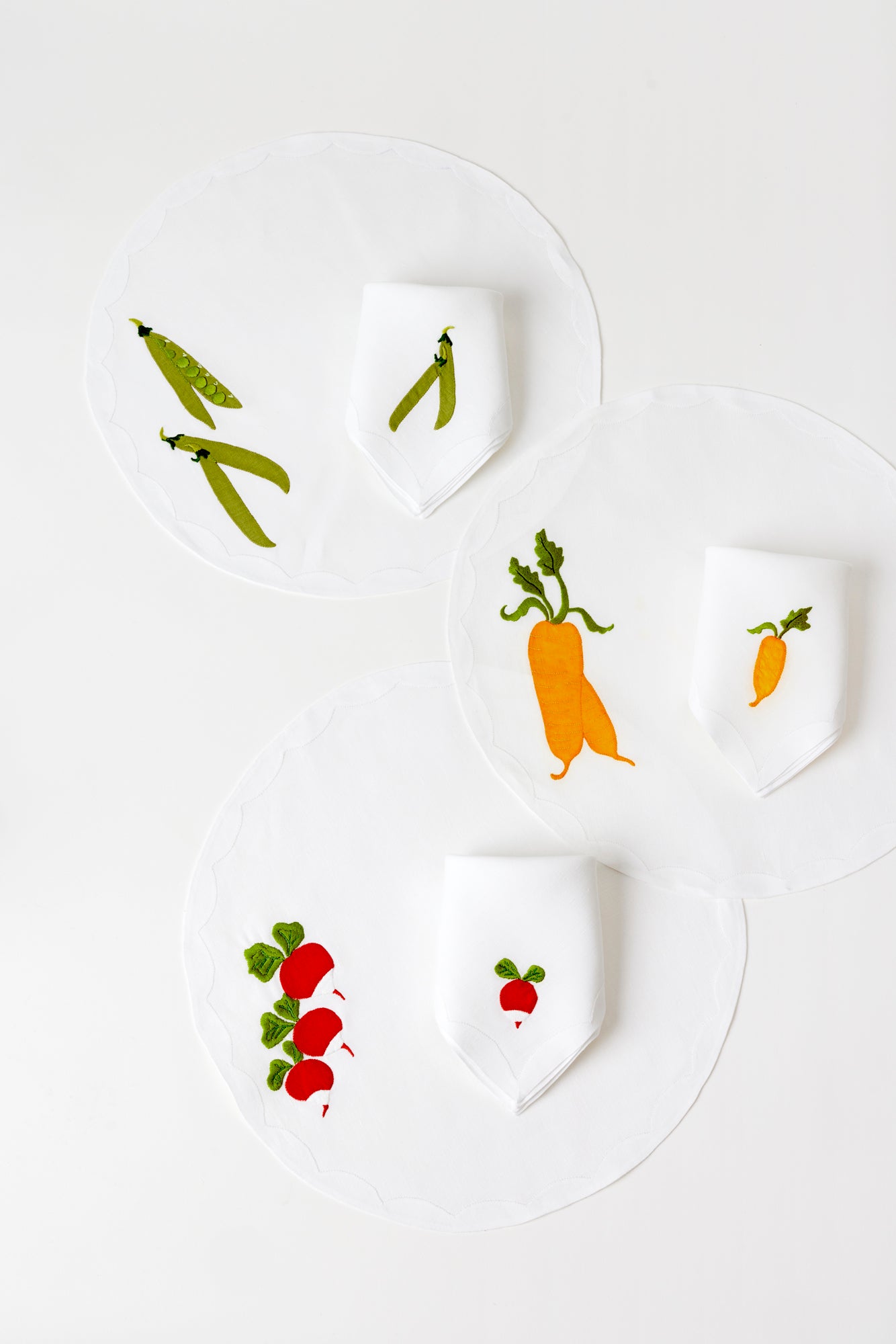 Set of six includes two placemats with snap pea, radishes, and carrots all stitched by hand appliqué in Madeira, Portugal.