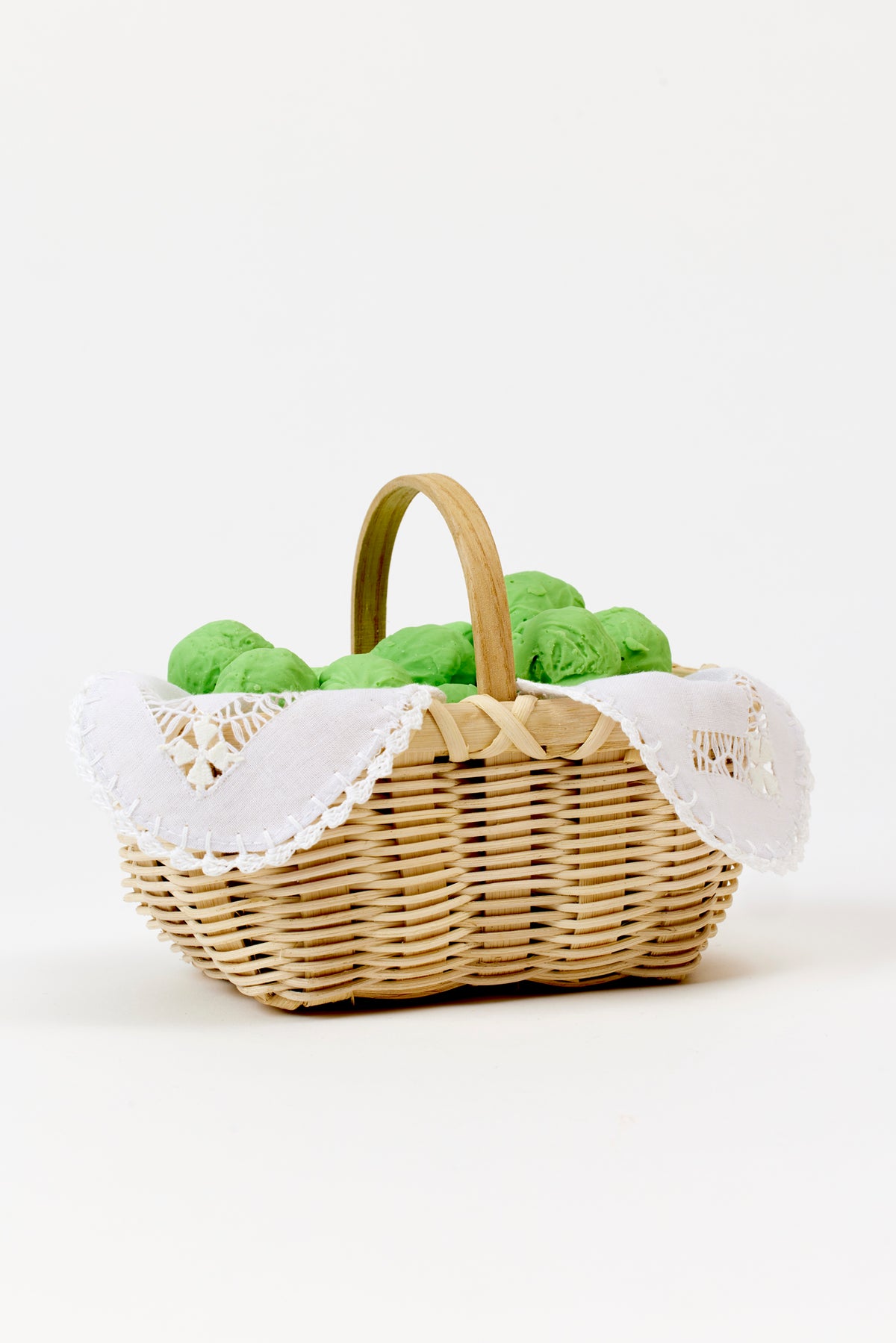 Handwoven basket with a delicate linen liner for serving cheese straws during cocktails.