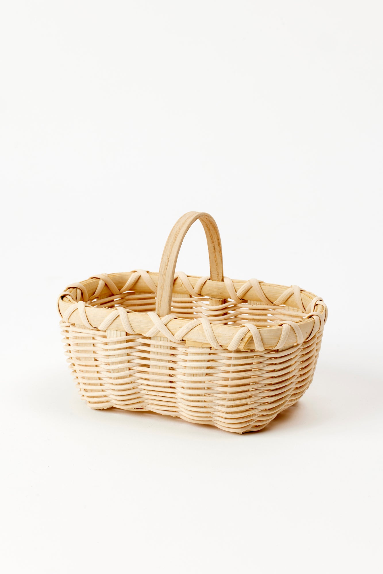 Handwoven basket with a delicate linen liner for serving cheese straws during cocktails.
