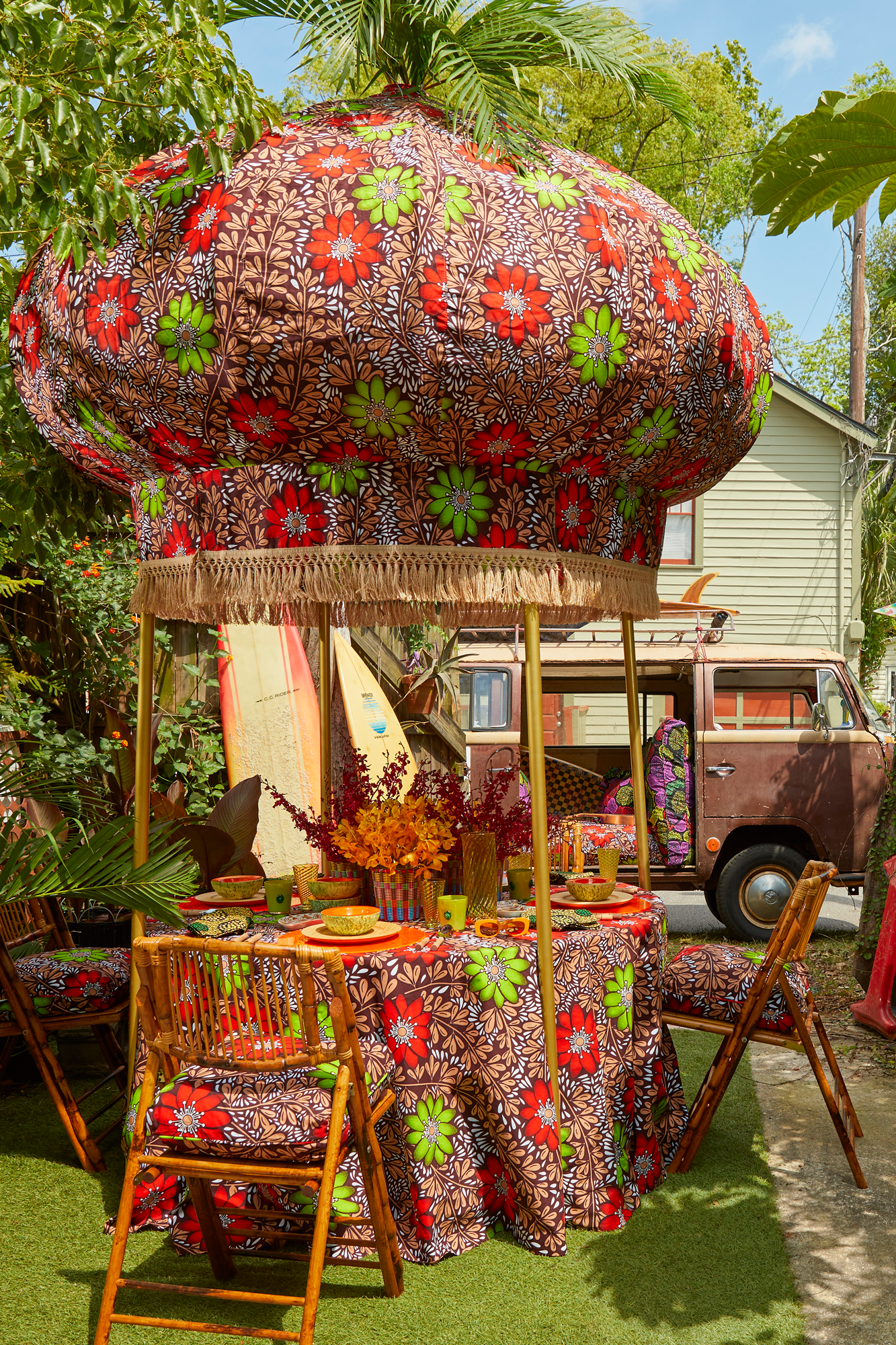 Onion canopy is upholstered with a removable Ankara cotton cover trimmed with jute fringe and finished with a functional vase finial for flamboyant plumes of ostrich feathers or showy palms.