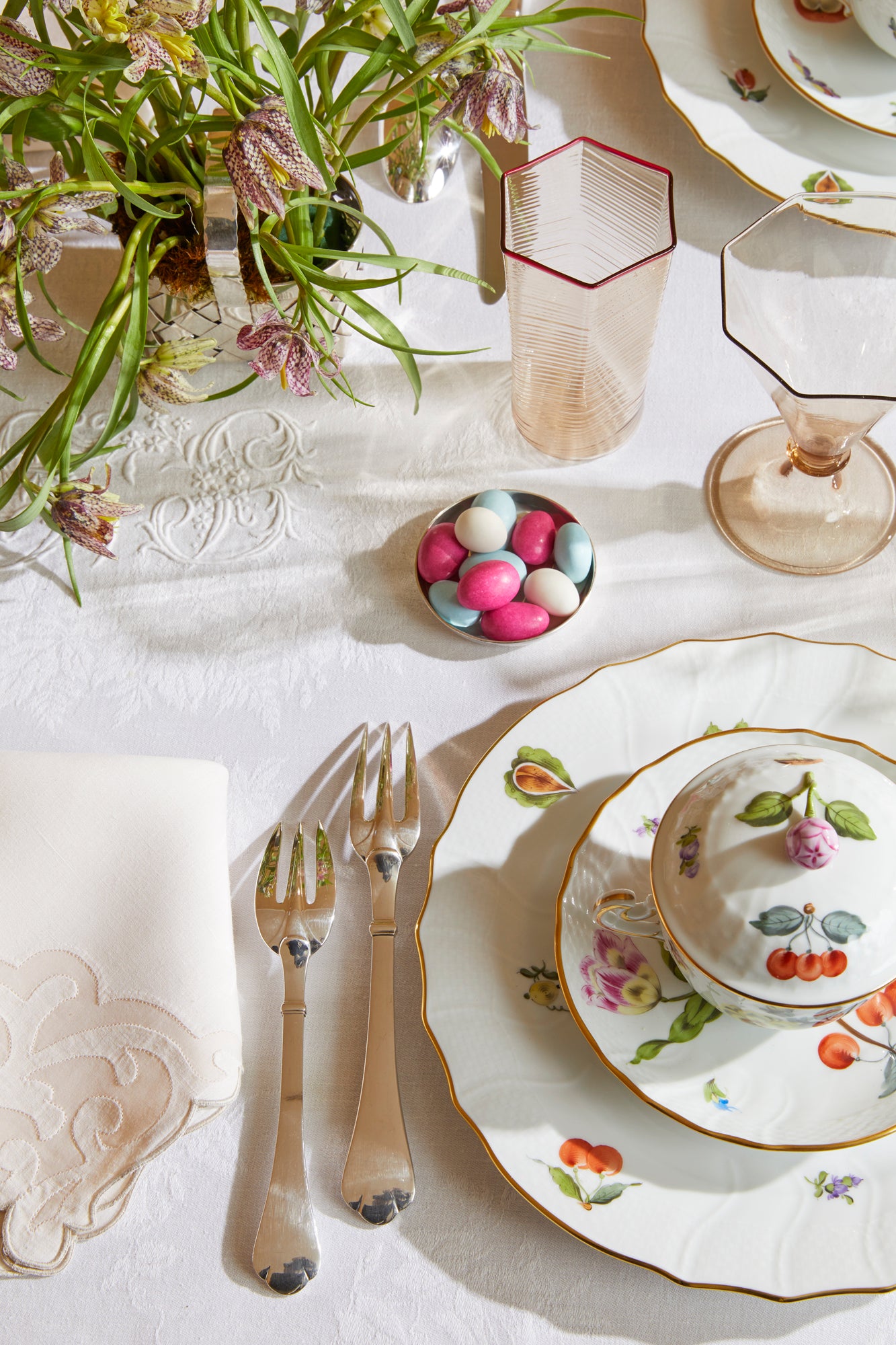 Porcelain dinnerware that has playful pattern surprises with tiny pink radishes, mushrooms and acorns.