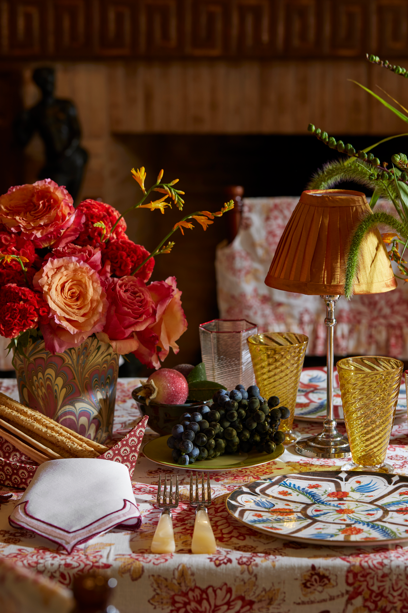 Table assorted with tableware and a ginger lamp shade.