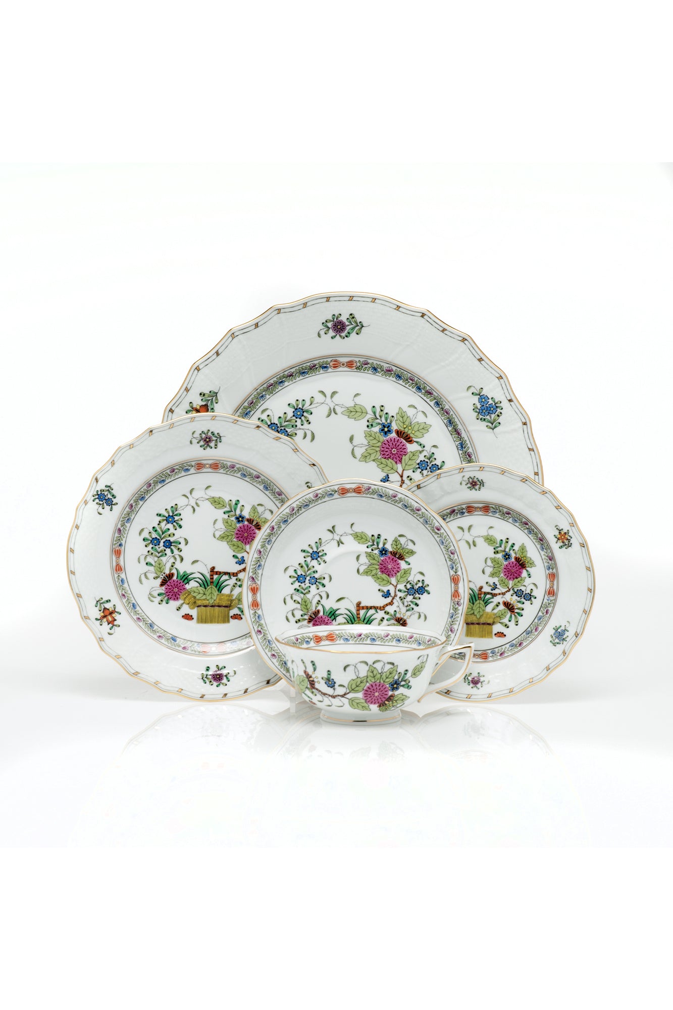 Porcelain dinnerware that has rich colors in an exotic pattern that stand alone with a solid cloth or add strong layers to a Bohemian look.
