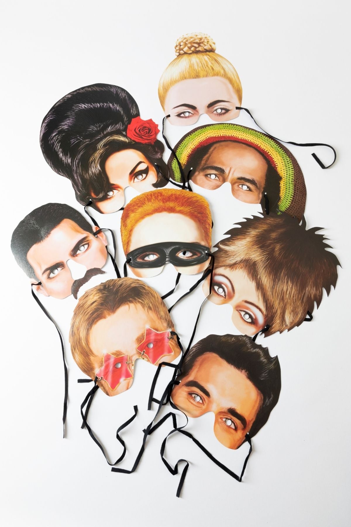 A fantastic set of eight die-cut and embossed half-face masks depicting Tina Turner, Robbie Williams, Amy Winehouse, Freddie Mercury, Madonna, Elton John, Bob Marley and Annie Lennox.