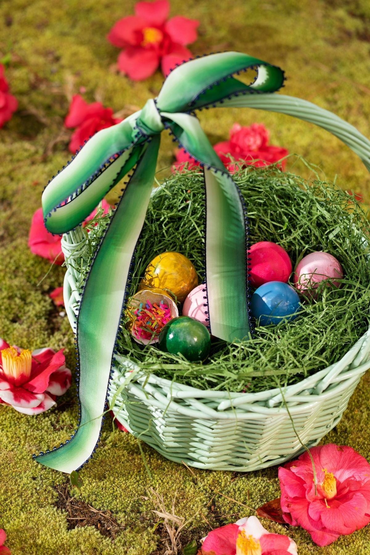 Carton of a colorful dozen eggs with confetti in them.