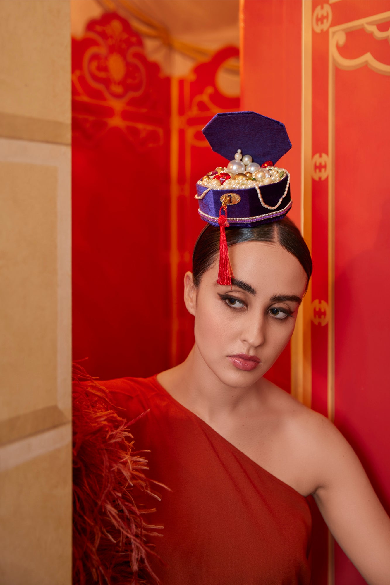 Headband with jewel box that includes pearls and jewels.