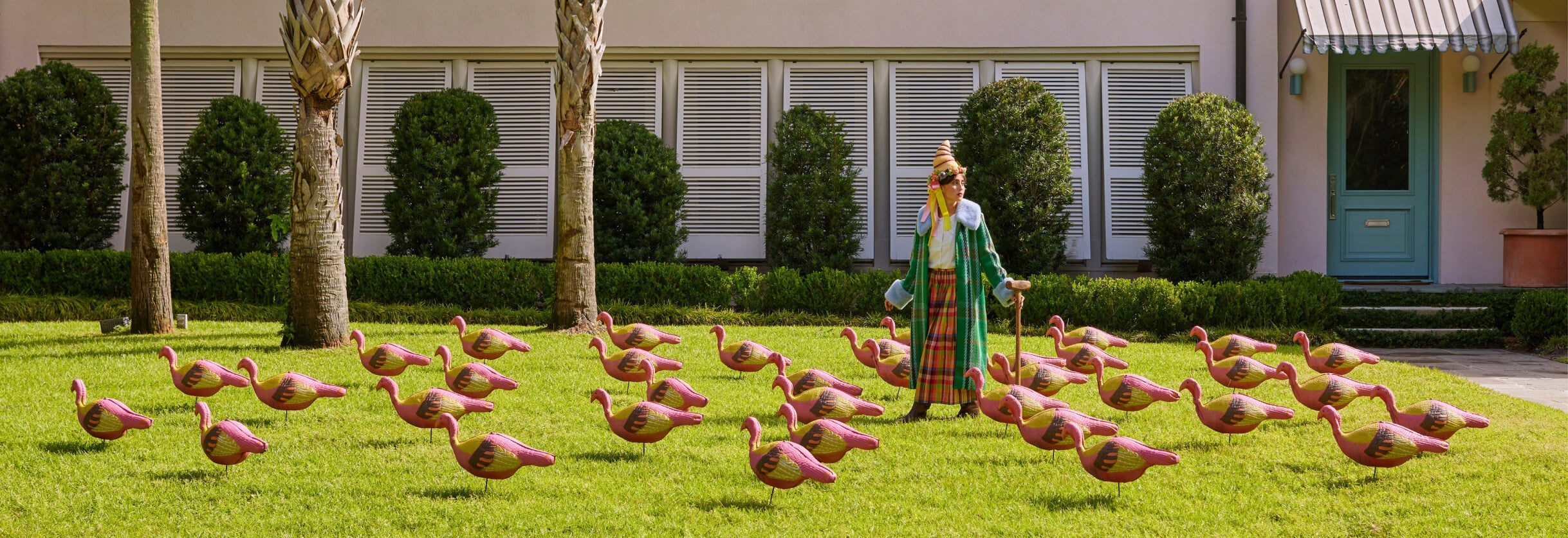 Woman wearing cornucopia hat at colorful table with chocolate turkeys