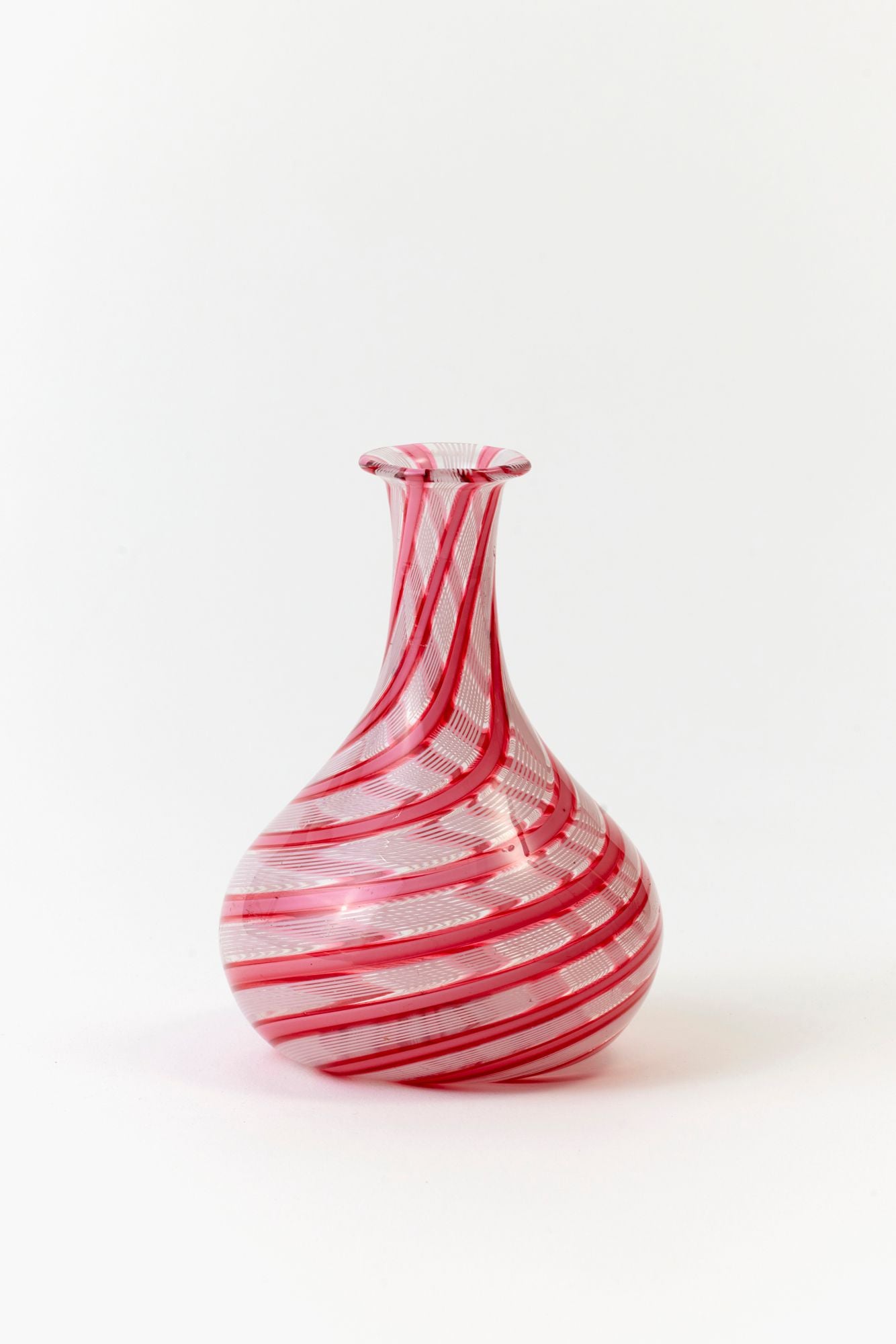 Red and white striped glass vase on a white background