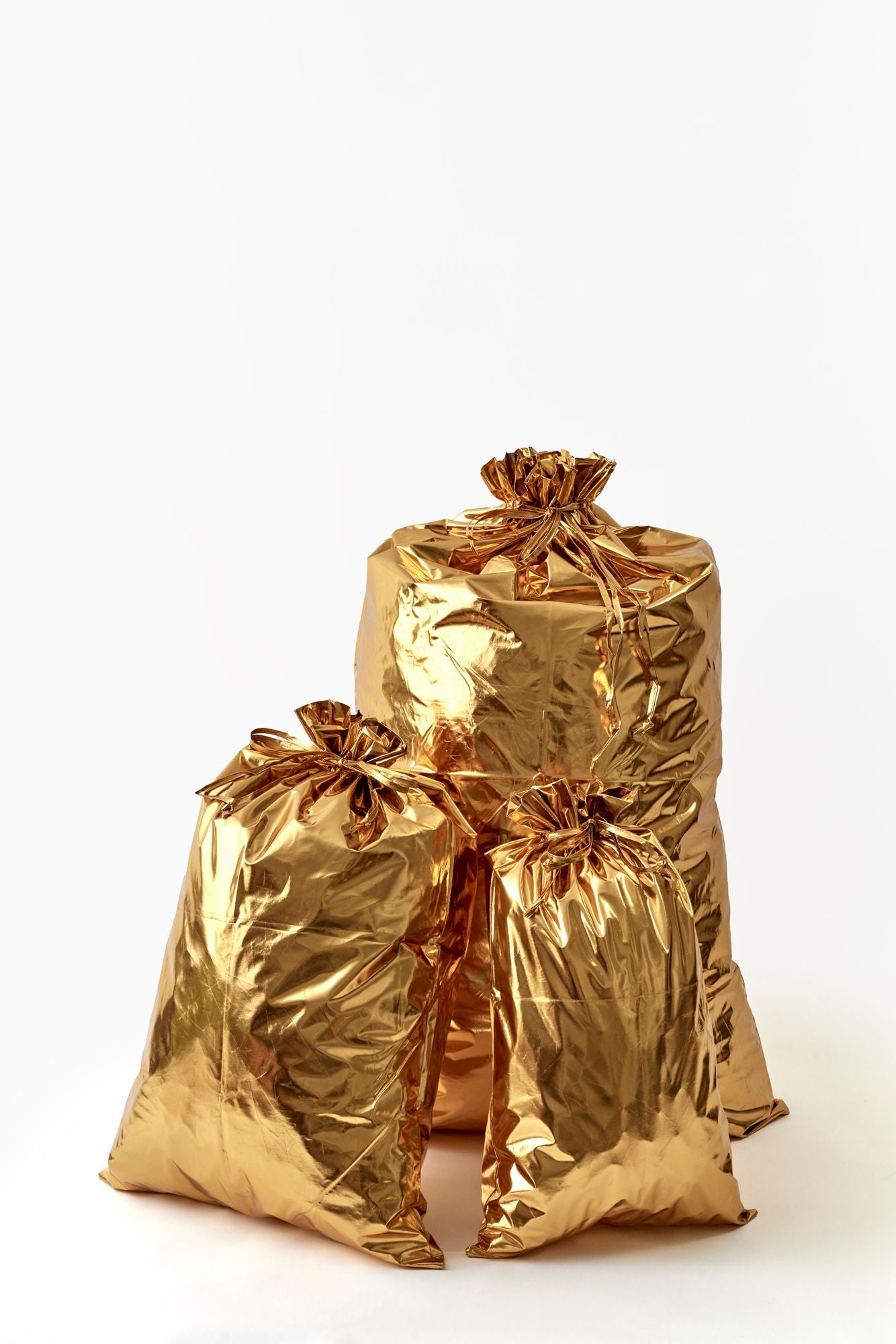 Two gold foil gift bags on a white background