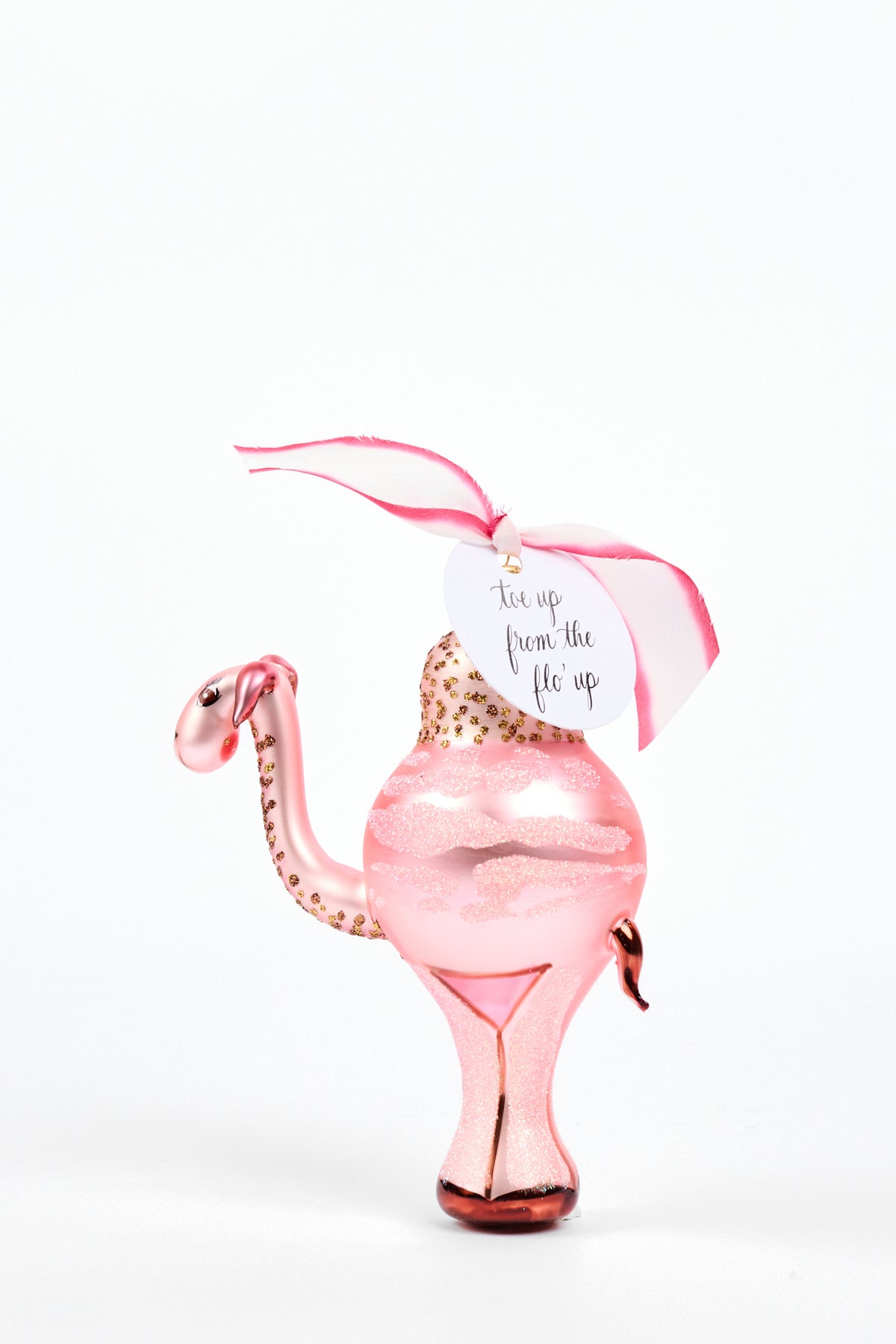 Pink Camel Ornament with pink and white silk ribbon and a tag that reads "toe up from the flo' up"