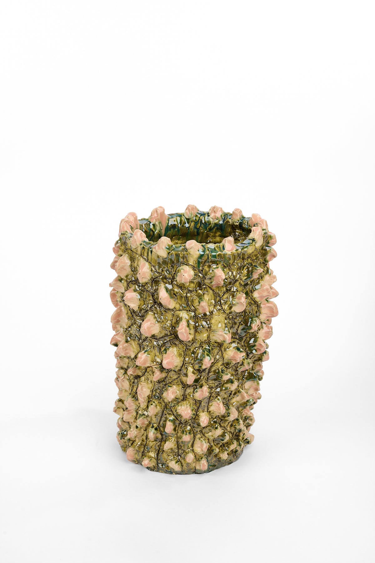 Tall cylindrical ceramic vase glazed in mottled olive and dark green. Its surface is densely covered with raised pale pink buds connected by thin, winding vine-like lines.