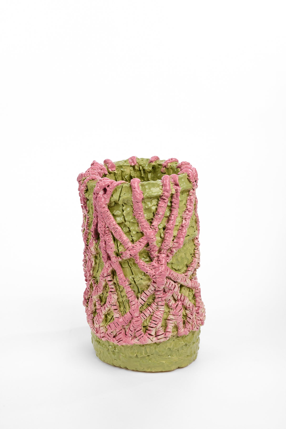 Tall cylindrical ceramic vase with a rough pale green surface. Raised pink bands loop and cross around the exterior in an irregular woven pattern.