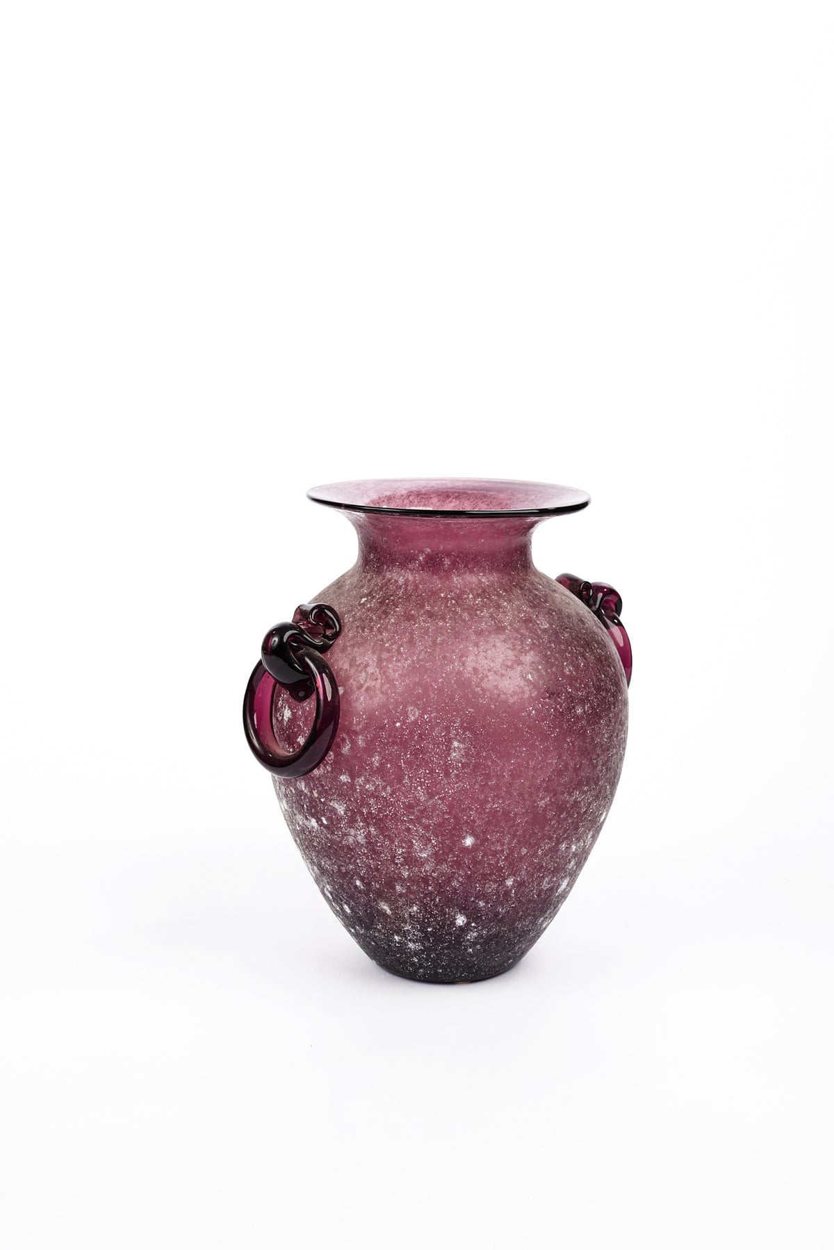 A vintage-style glass vase with a textured, speckled burgundy and purple body, featuring two dark metal ring handles on the sides, set against a plain white background.