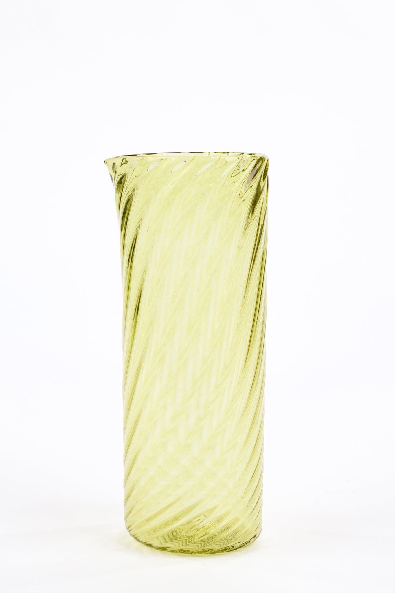 A tall, cylindrical glass pitcher with a spiral swirl pattern in pale yellow-green, set against a plain white background.