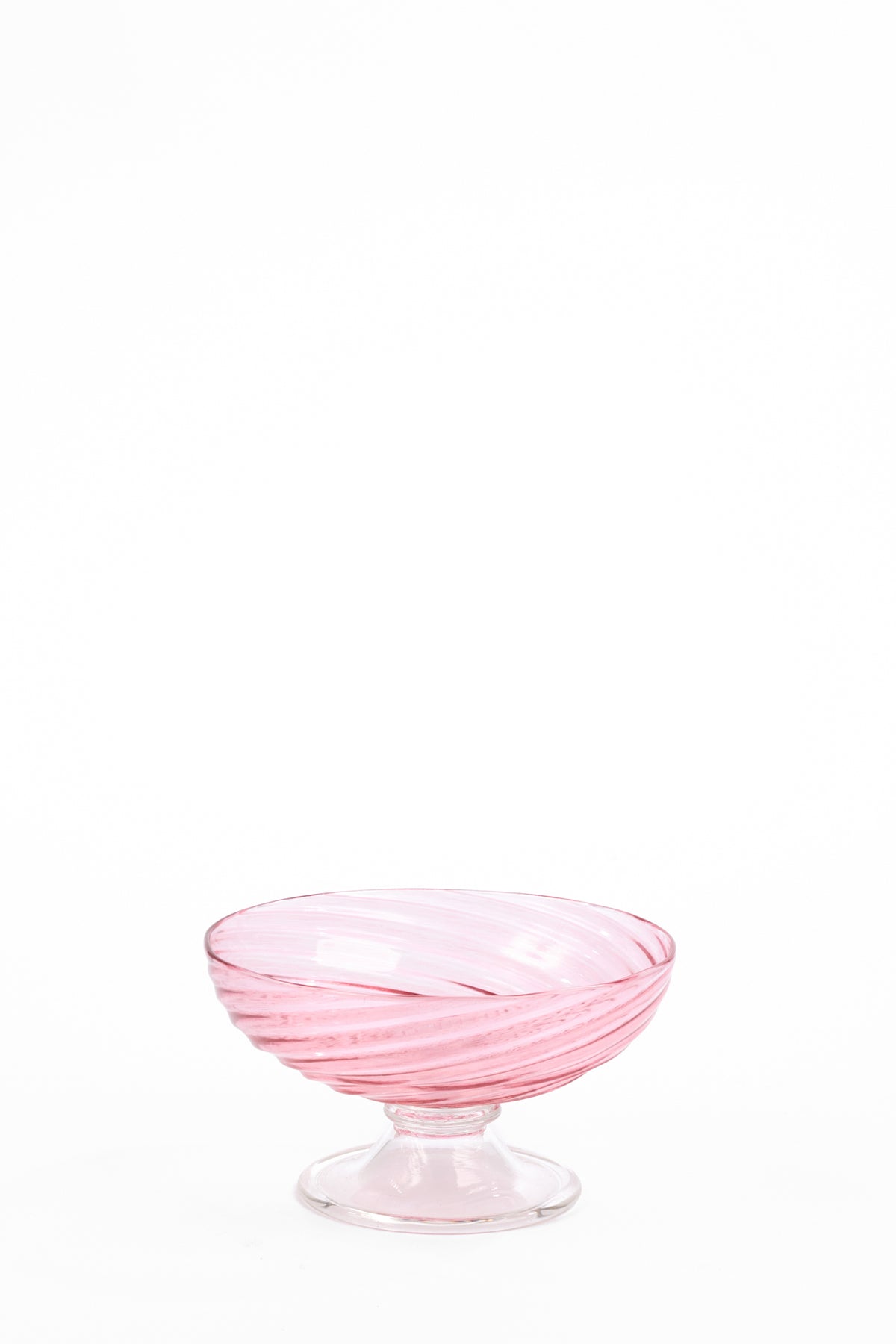 Pale pink glass compote with a wide, shallow bowl, short stem, and round foot. Translucent pink bands spiral around the bowl from the base to the rim.