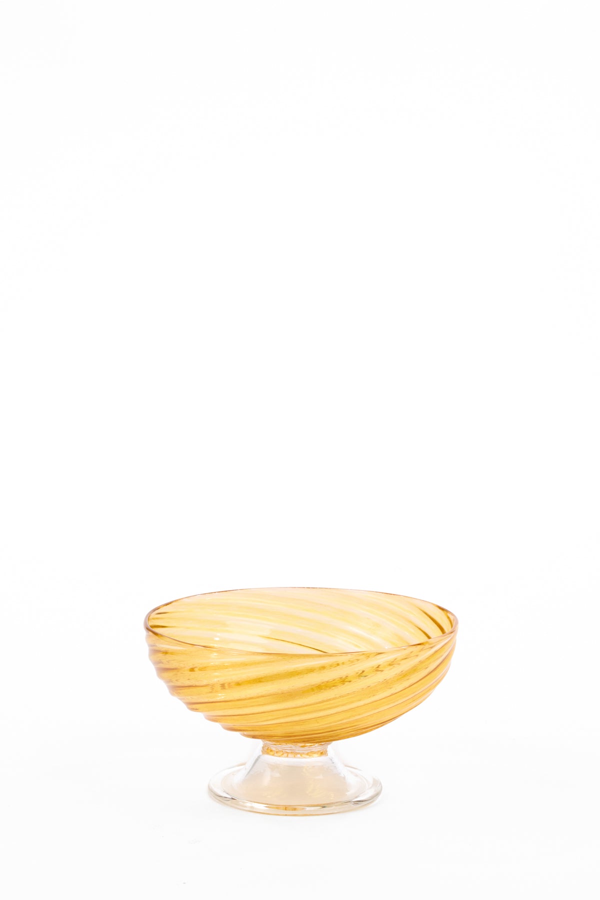 Amber glass compote with a wide, shallow bowl, short stem, and round foot. Translucent golden bands spiral around the bowl from the base to the rim.